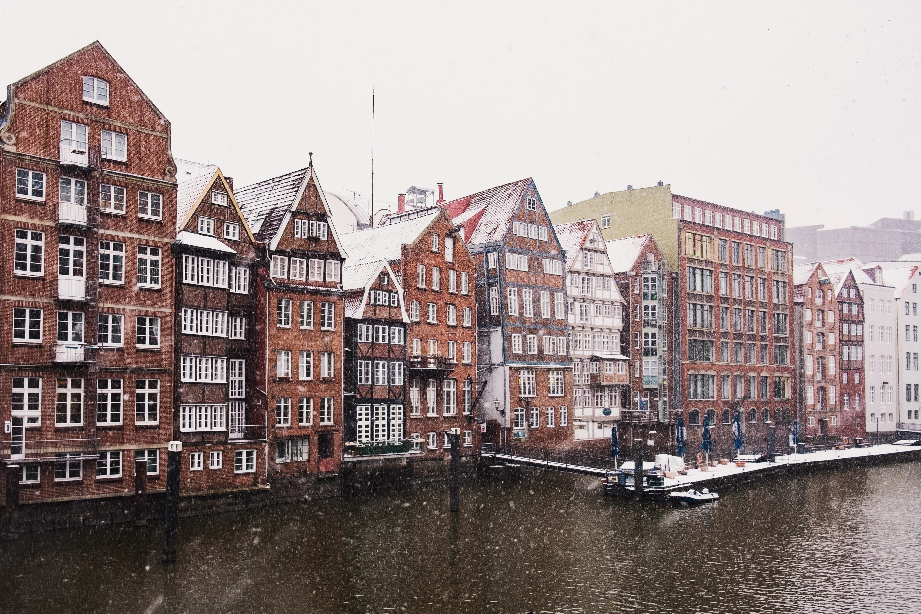 brown and red concrete building beside river during daytime