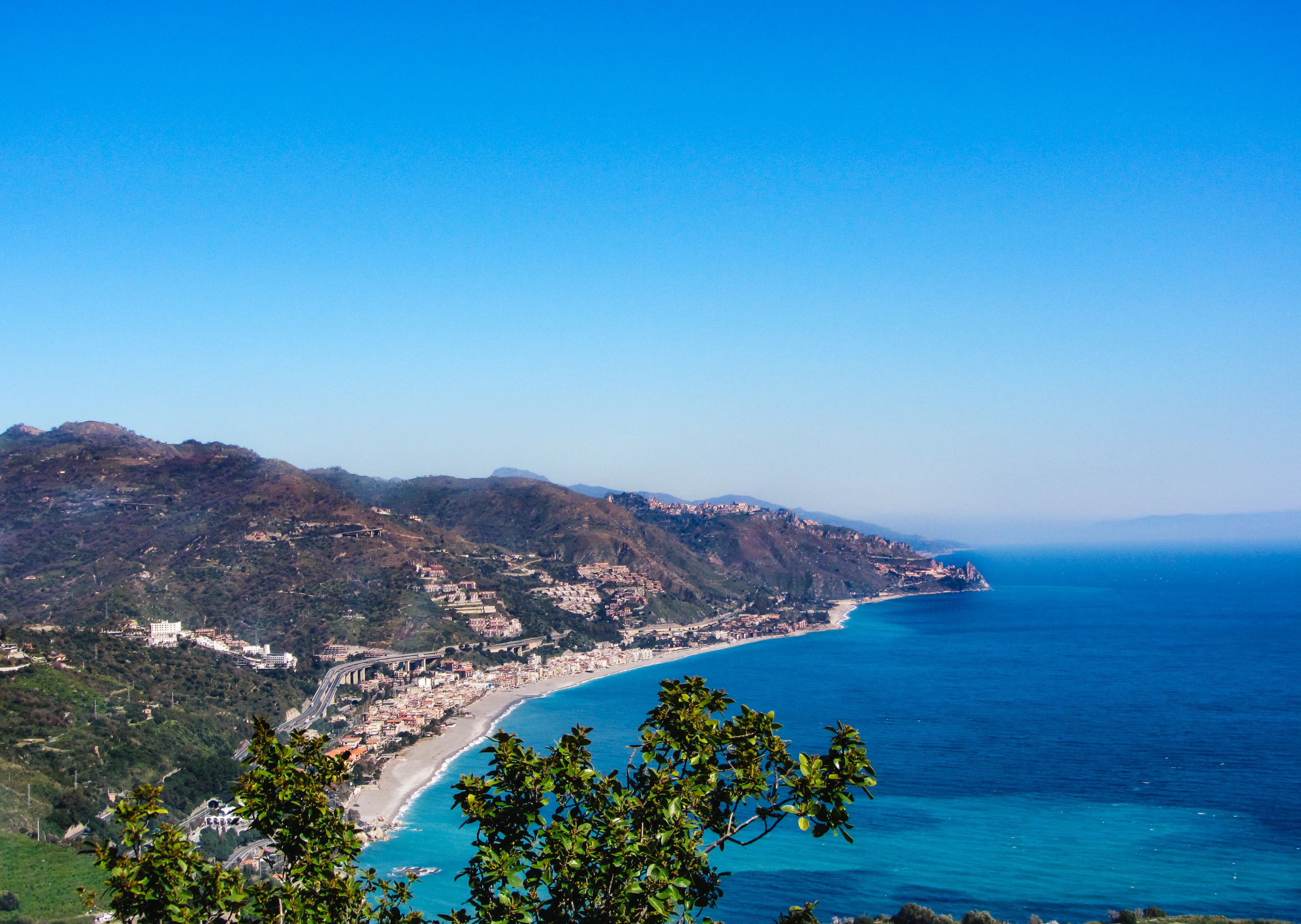 a scenic view of a beach and the ocean