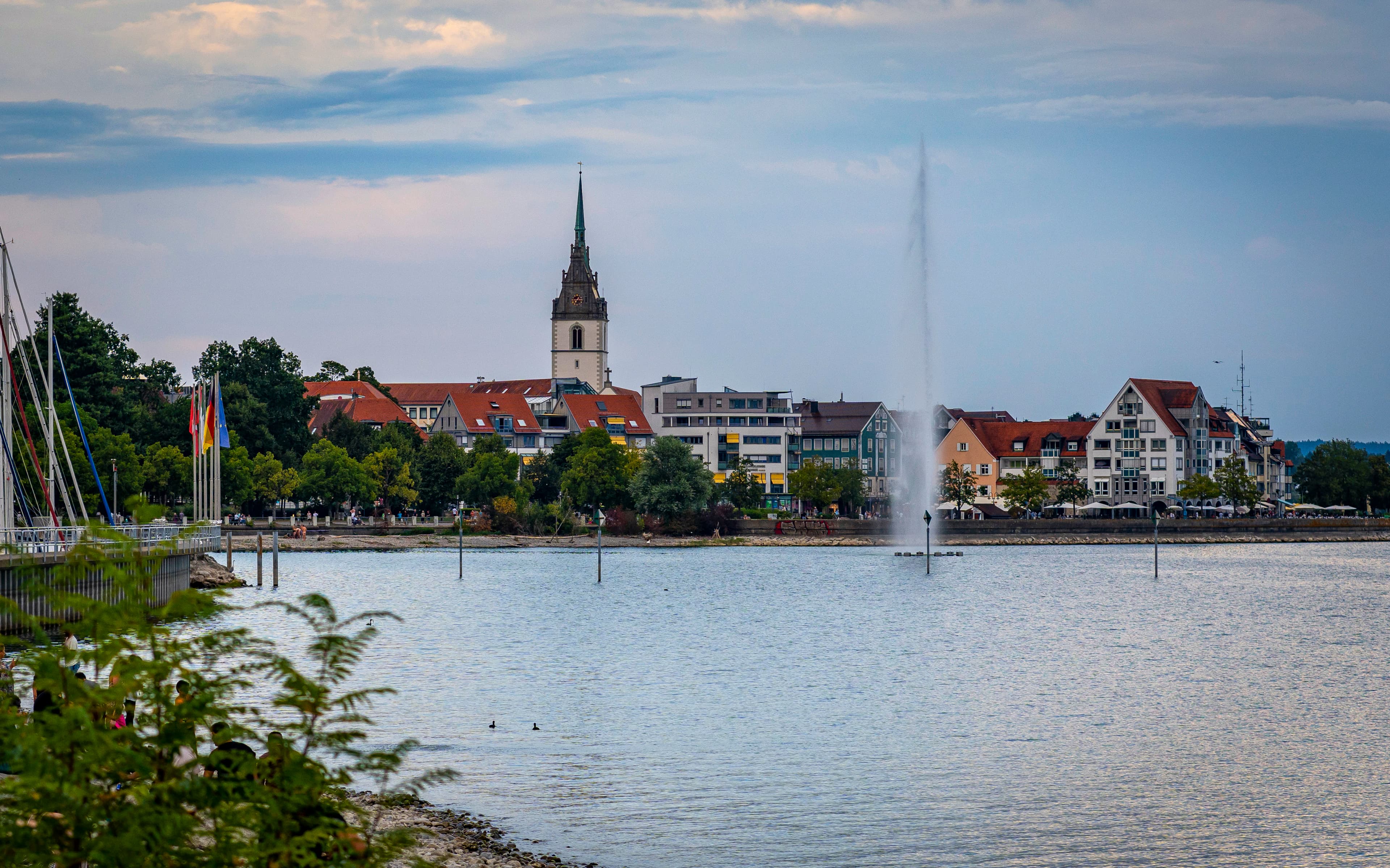 A large body of water with a clock tower in the background