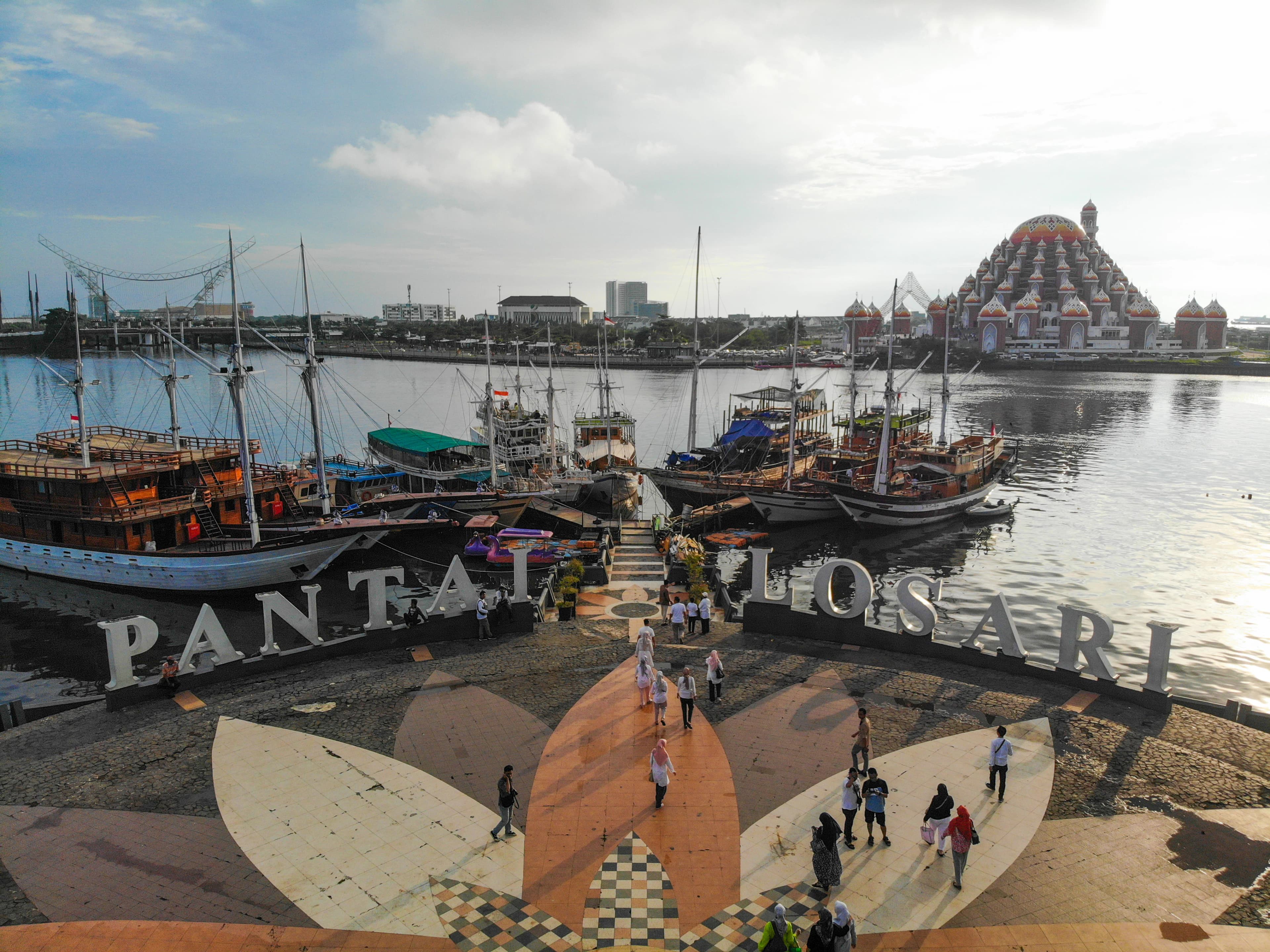 a group of boats docked at a pier