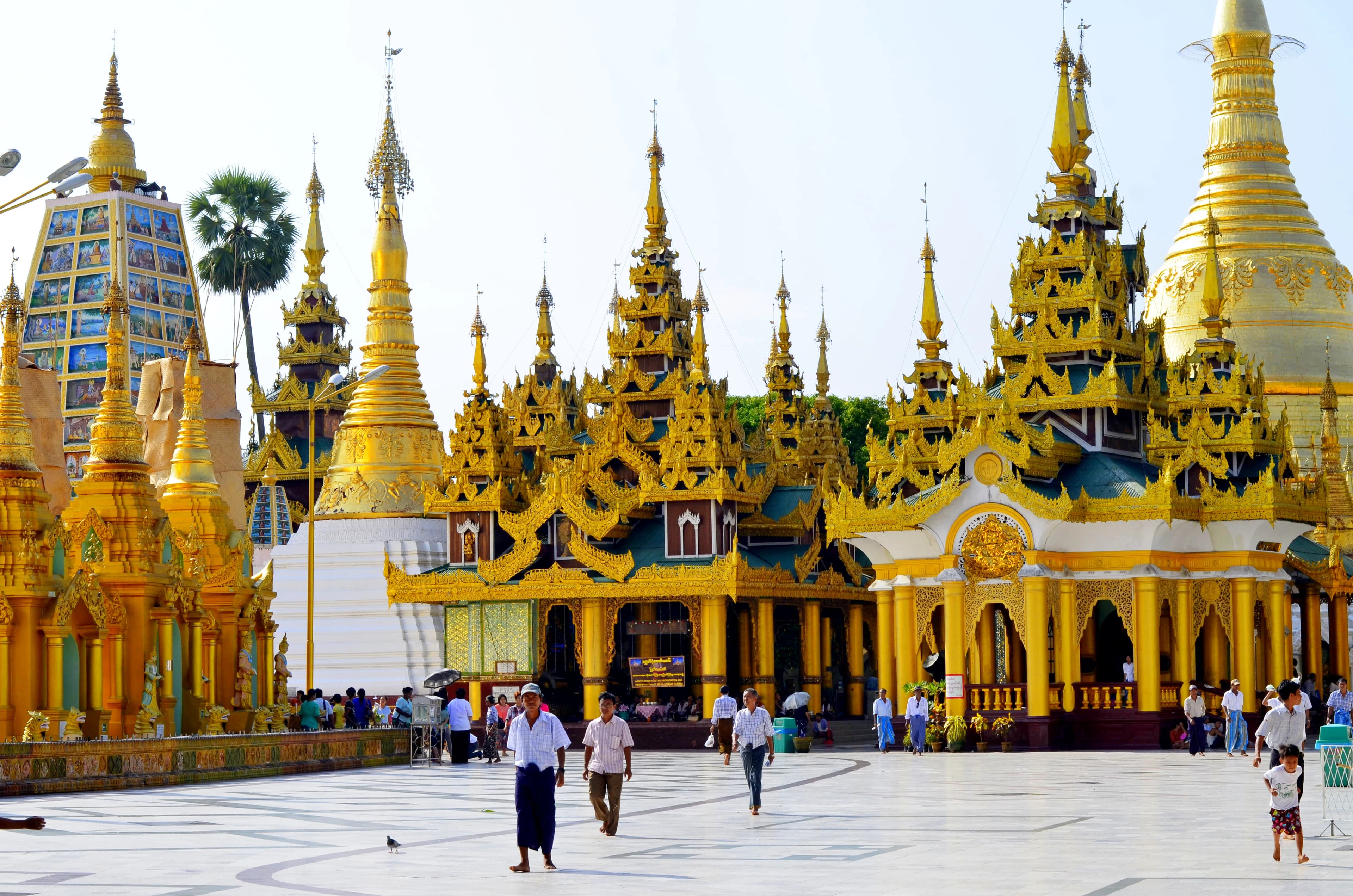 people walking near yellow and white concrete building during daytime