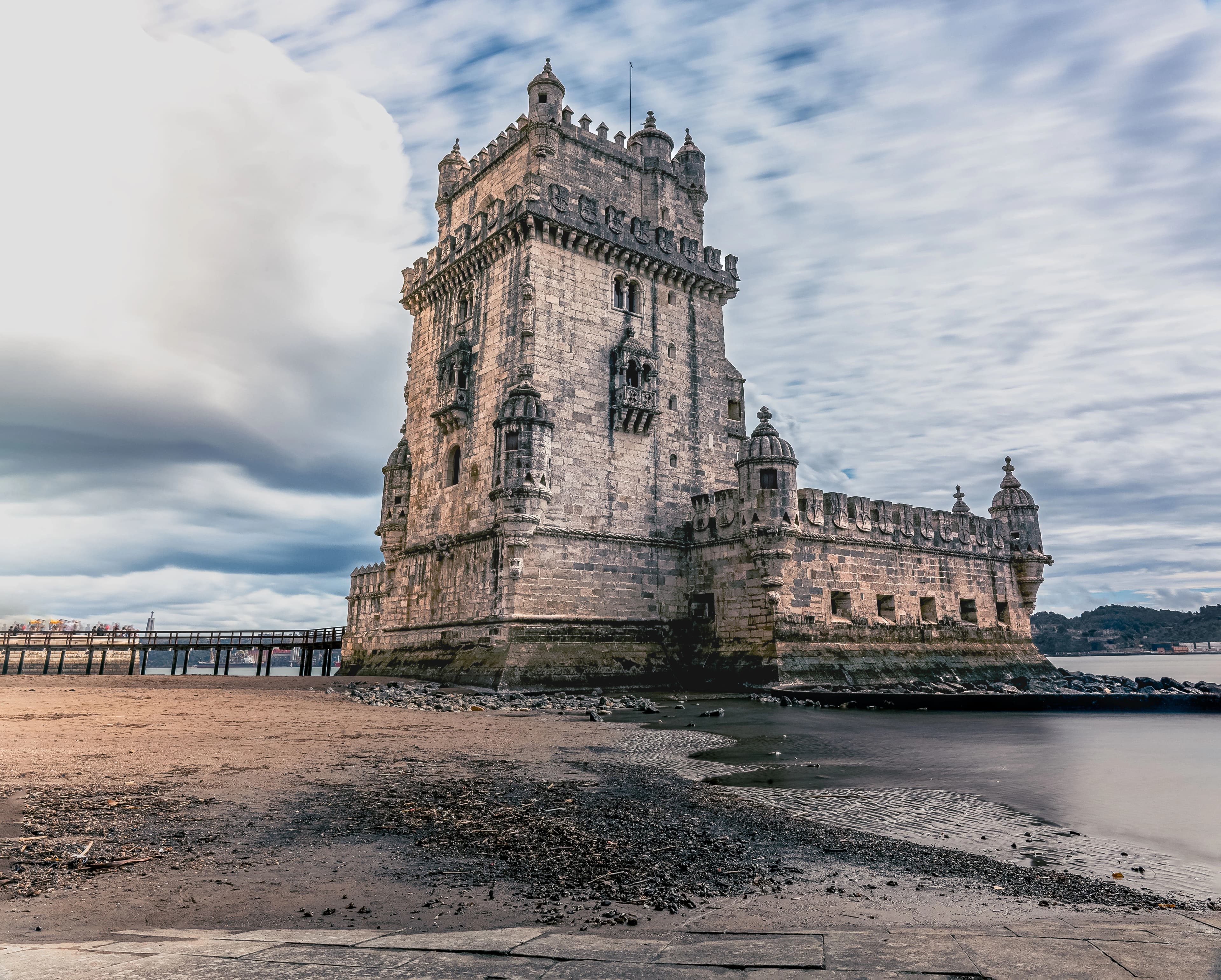 a very tall tower sitting on top of a sandy beach