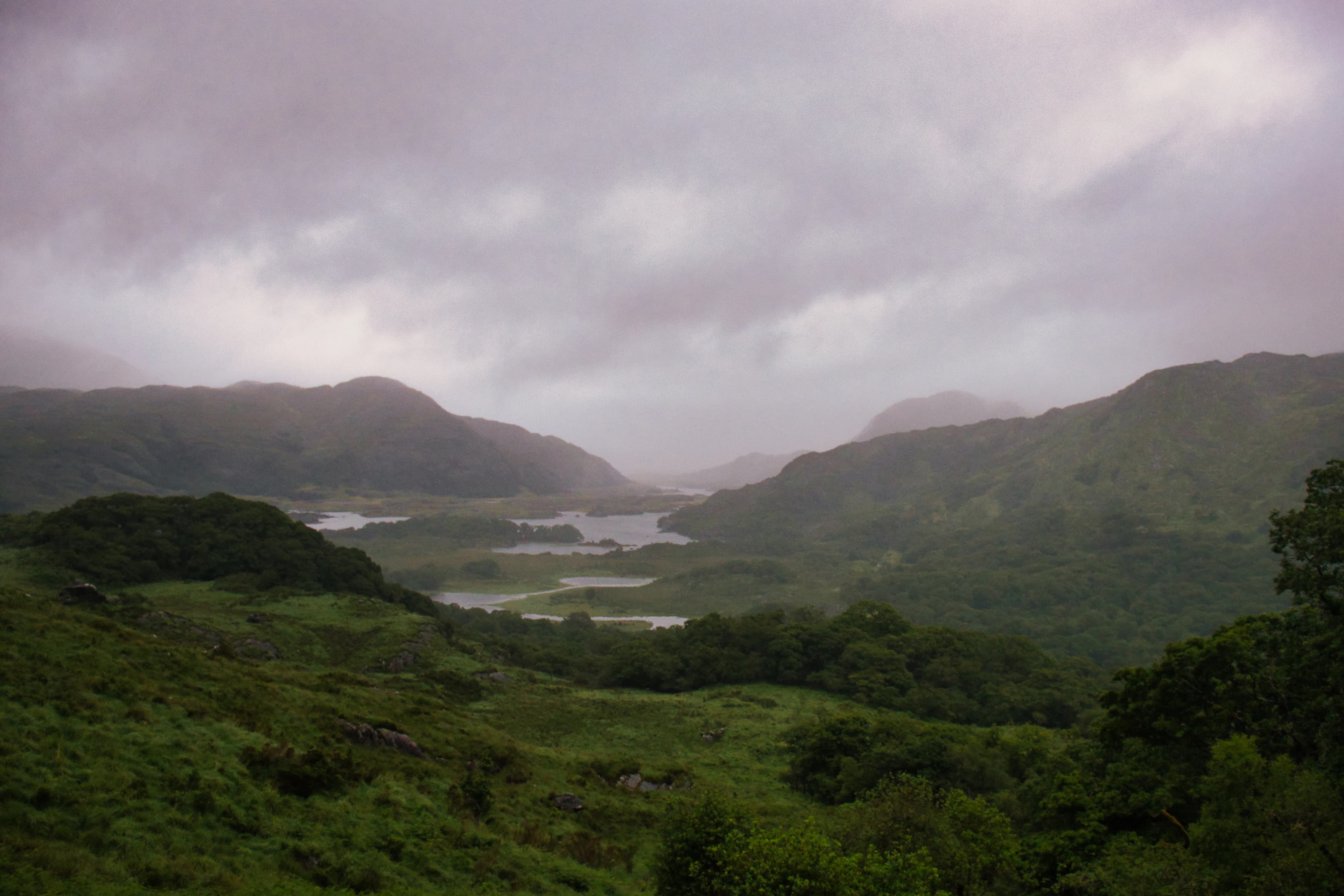 Misty mountains and lakes under a cloudy sky