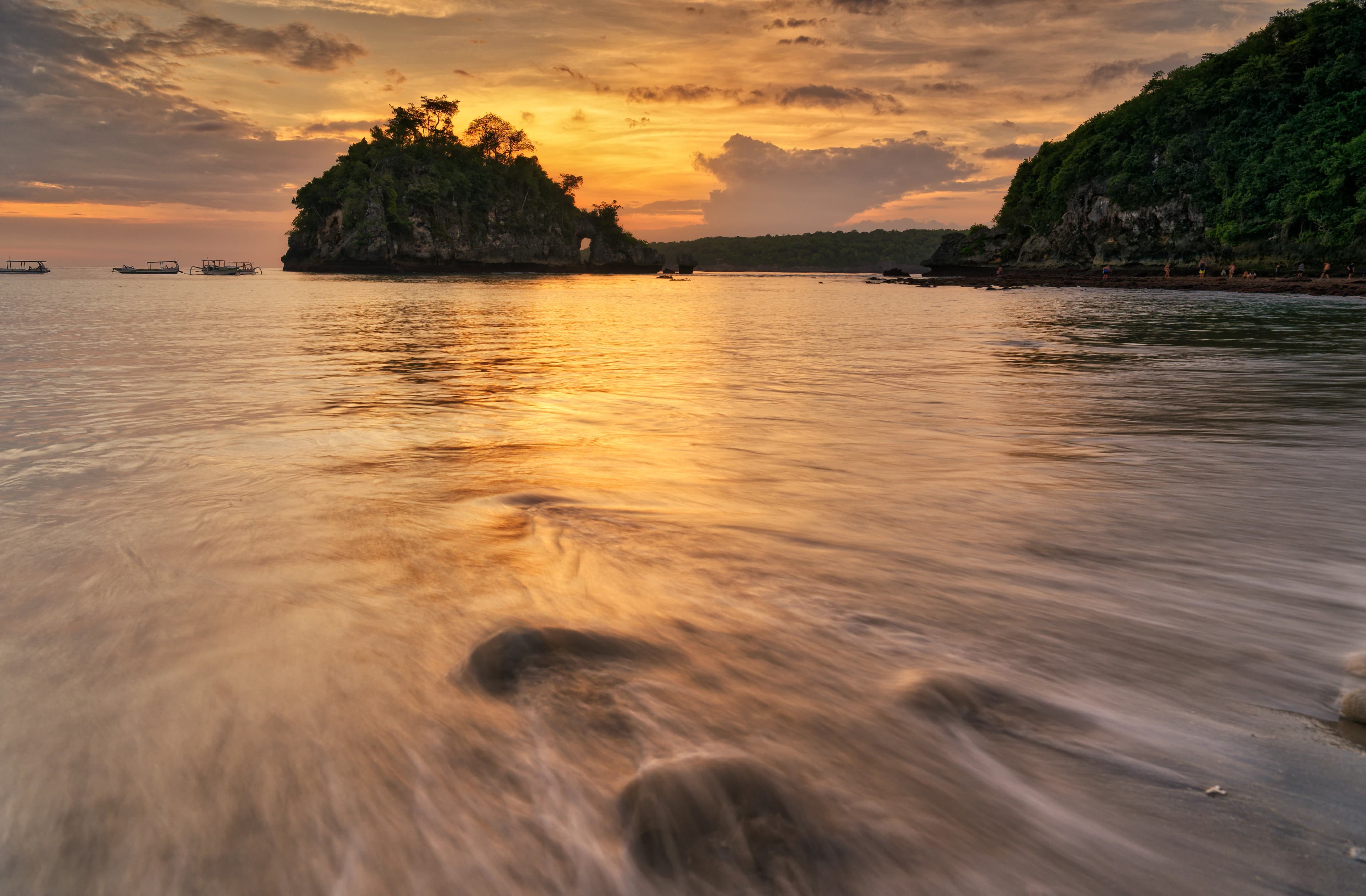 A body of water with a small island in the background
