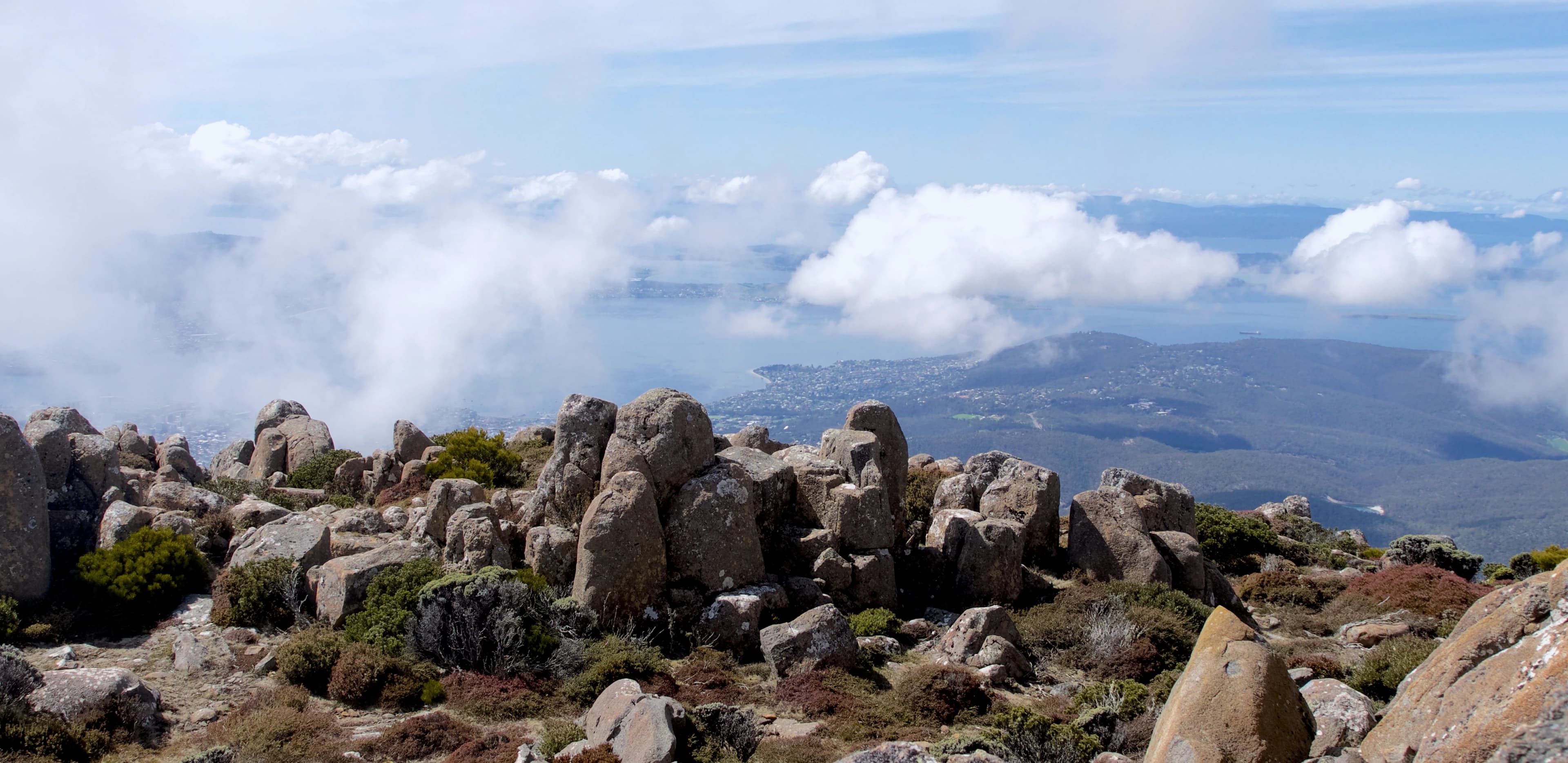a rocky landscape with clouds in the background