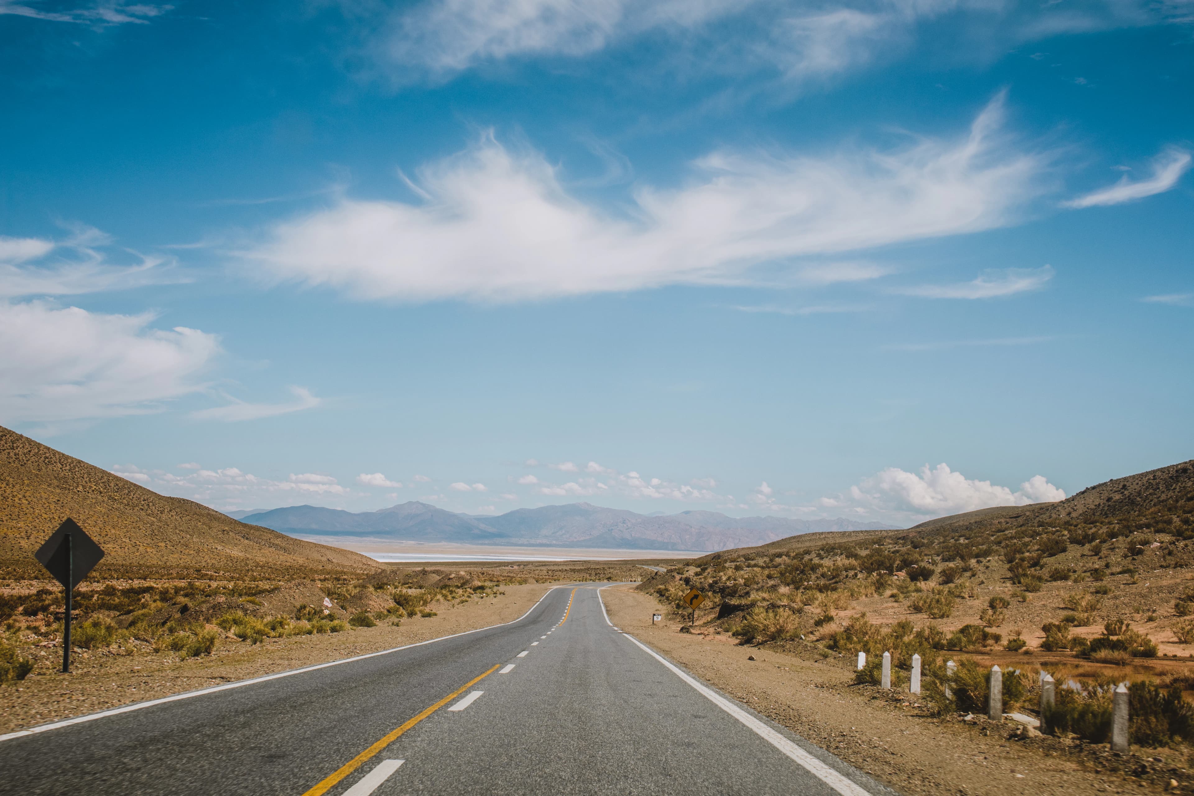 an empty road in the middle of a desert