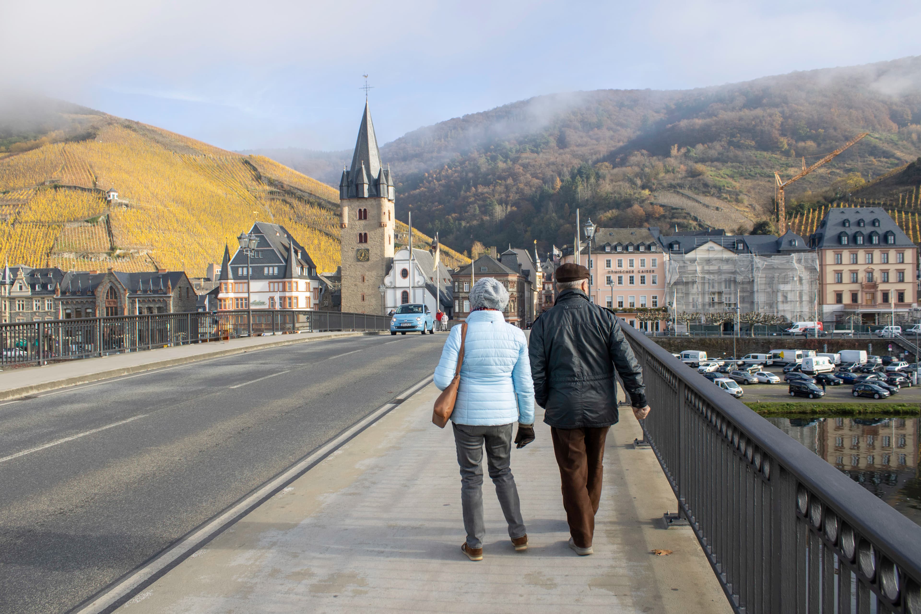 a man and a woman walking on a bridge