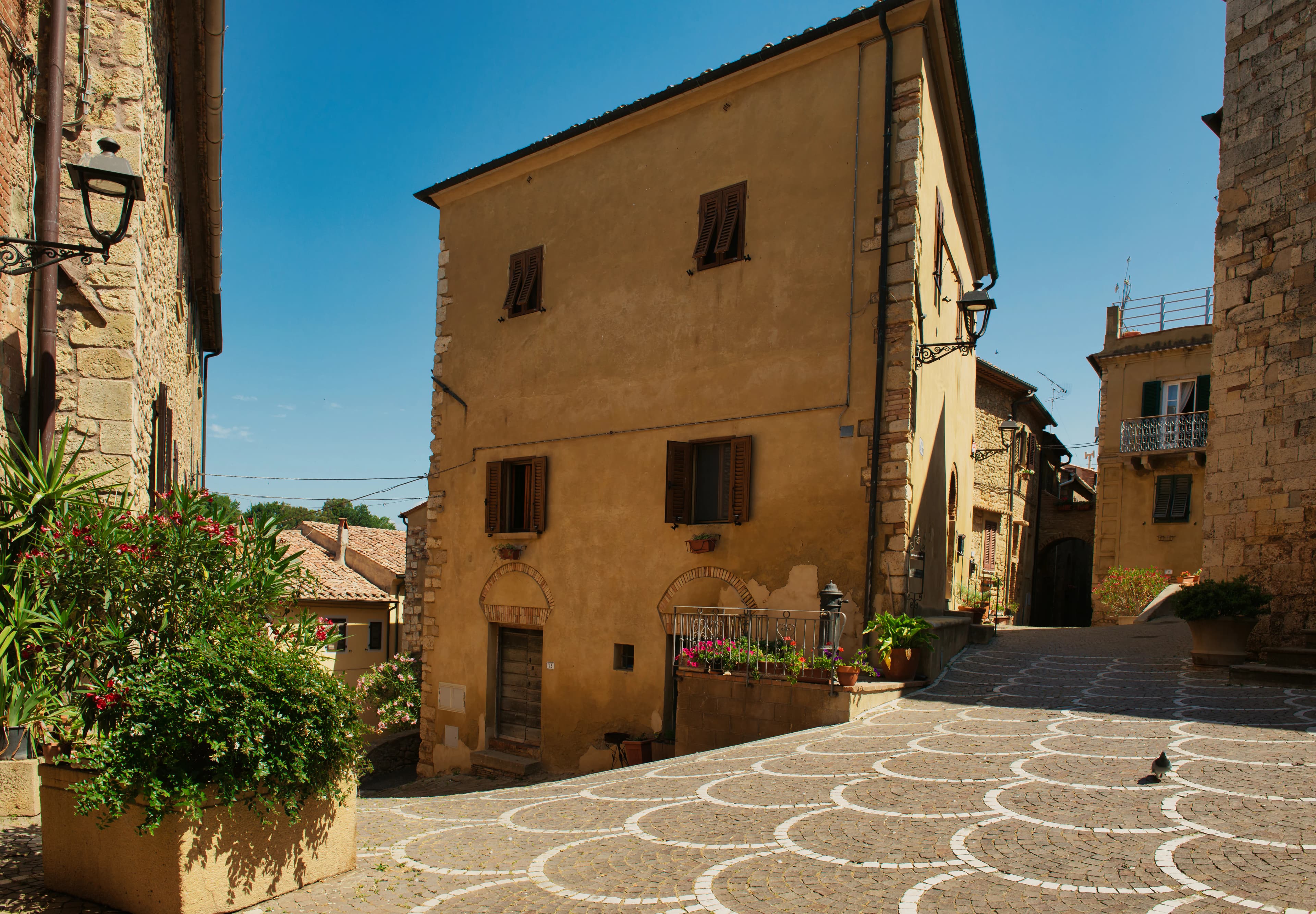 Old european town square with historic buildings and cobblestone pavement.