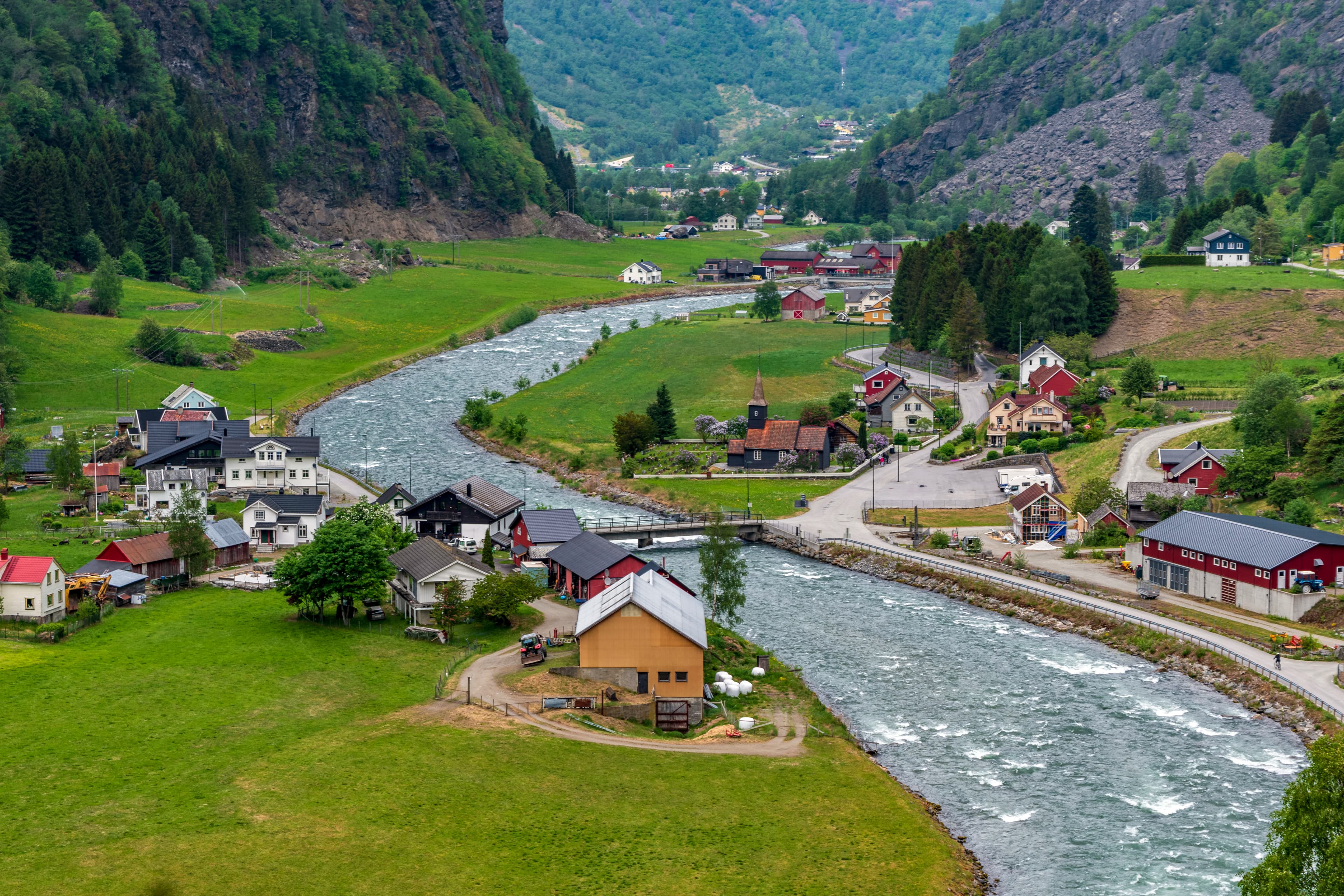 A river running through a lush green valley