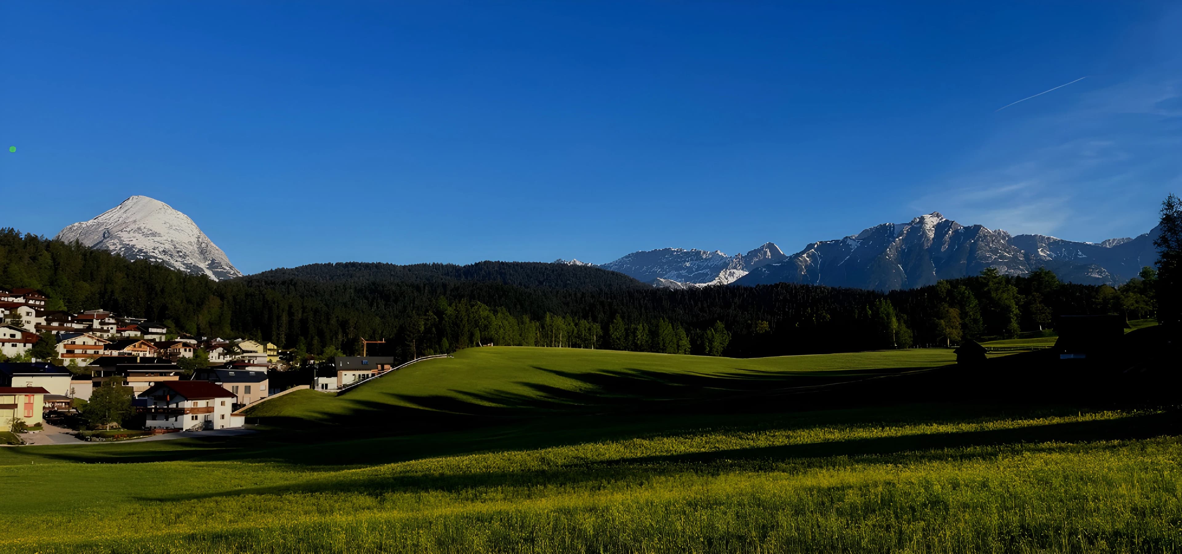 A small village in the middle of a green field