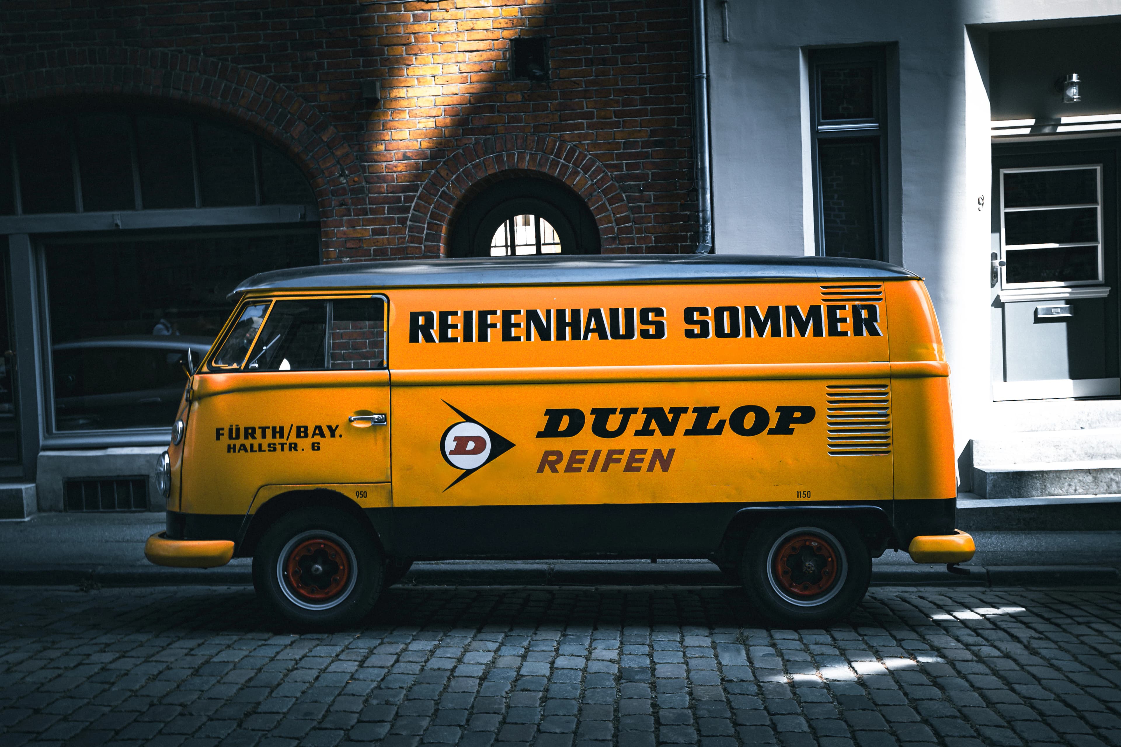 A yellow van parked in front of a building