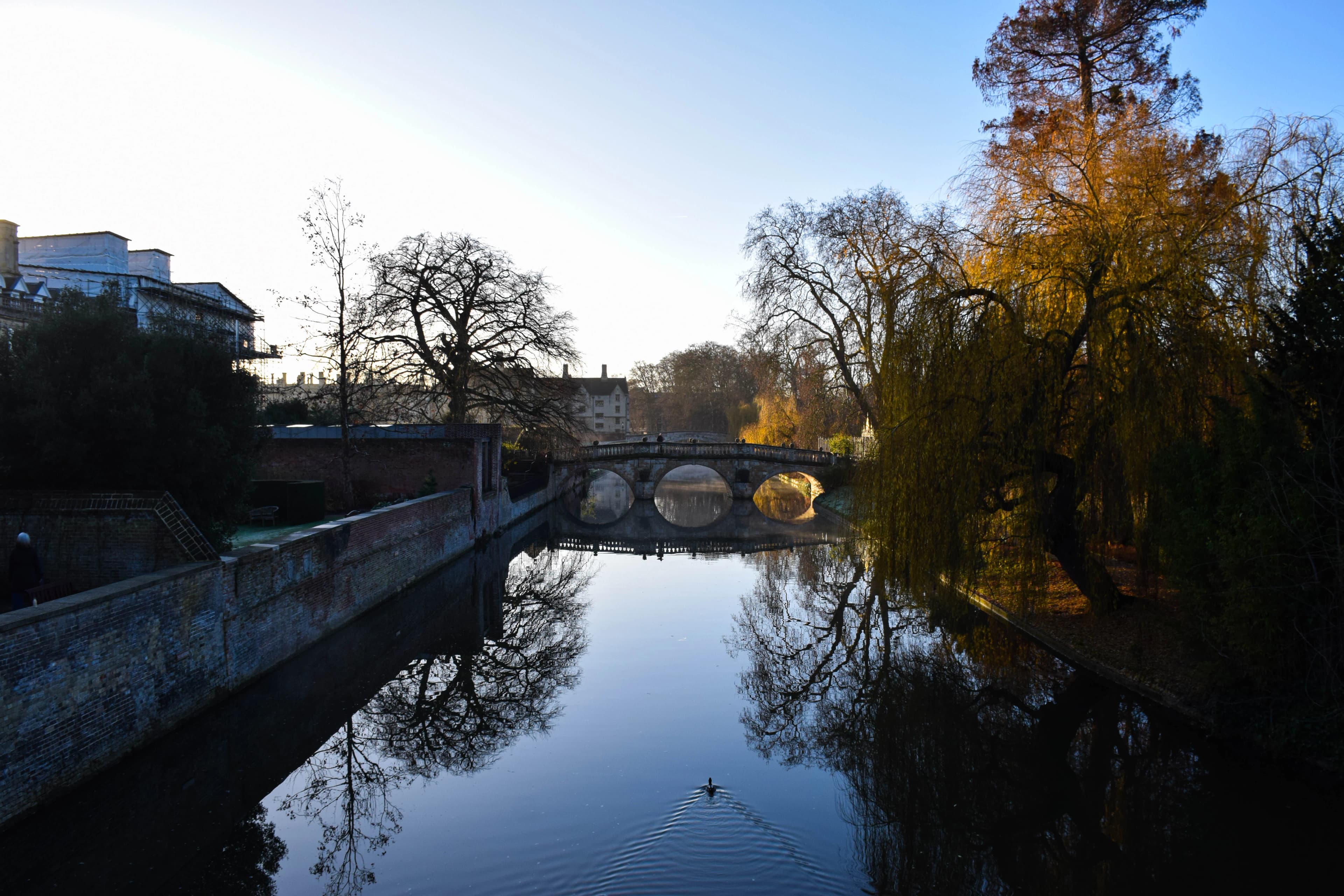 River with bridge and autumn trees reflecting