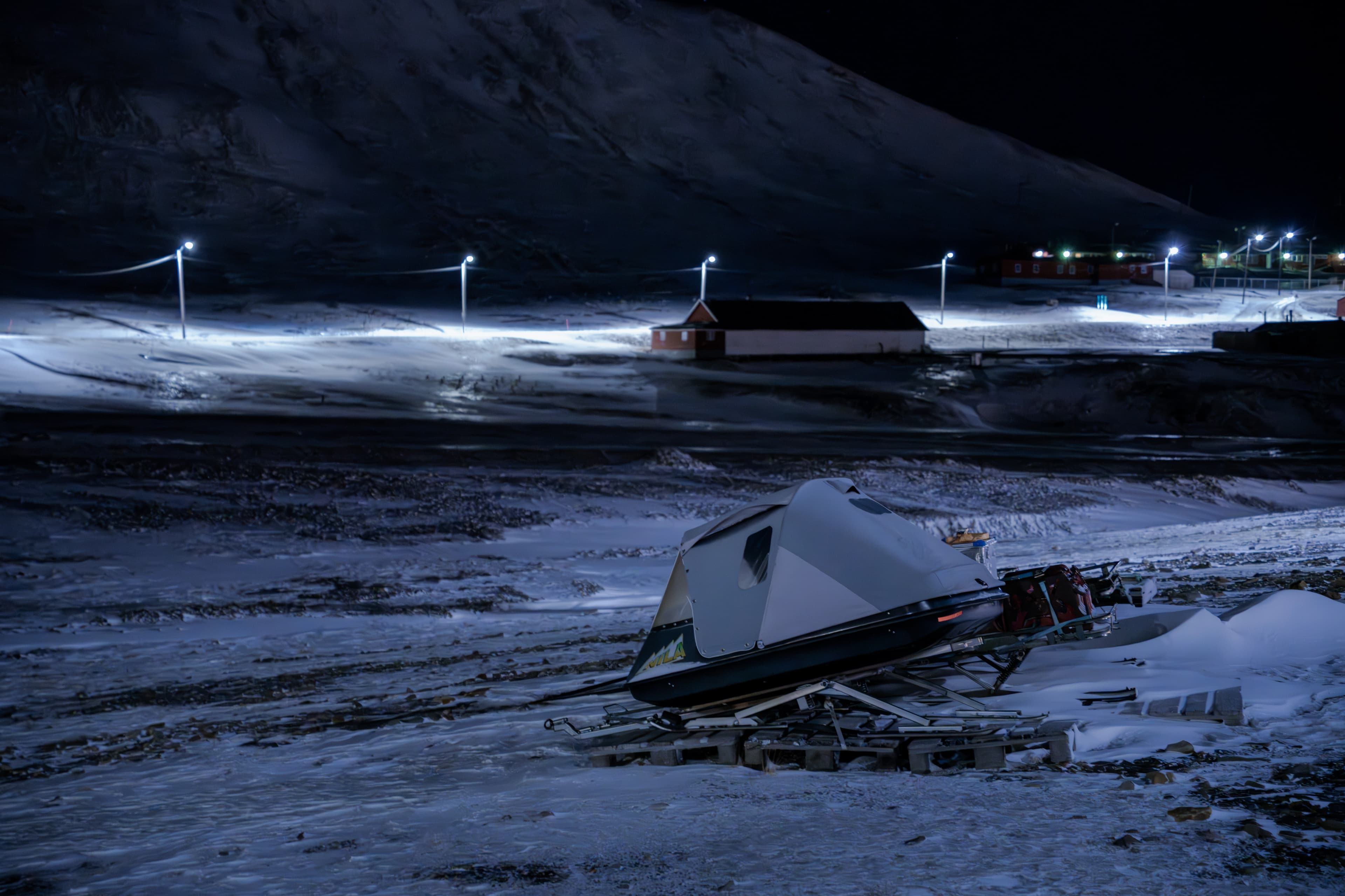 a camper sits in the middle of a snowy field