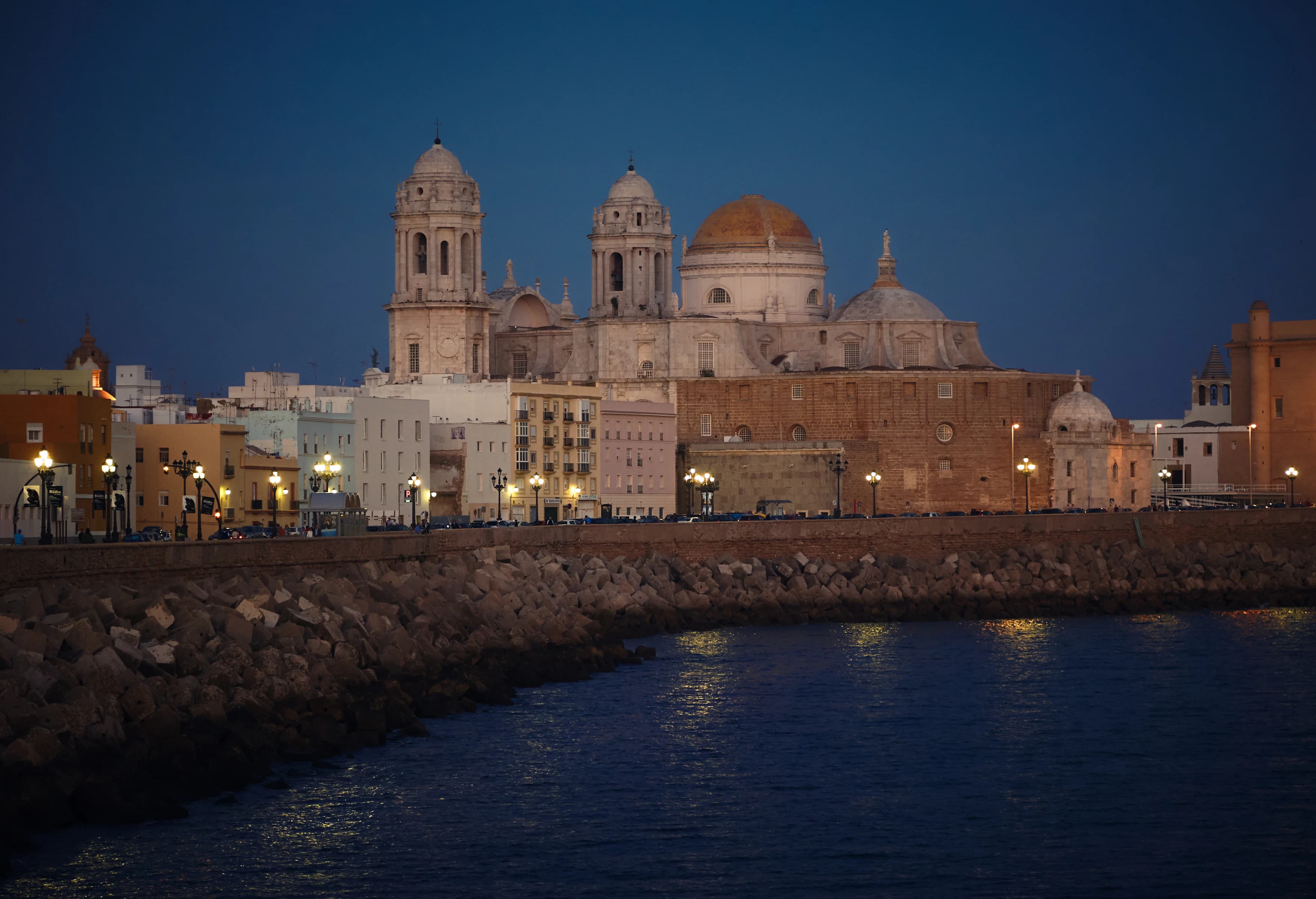 white and brown mosque near body of water
