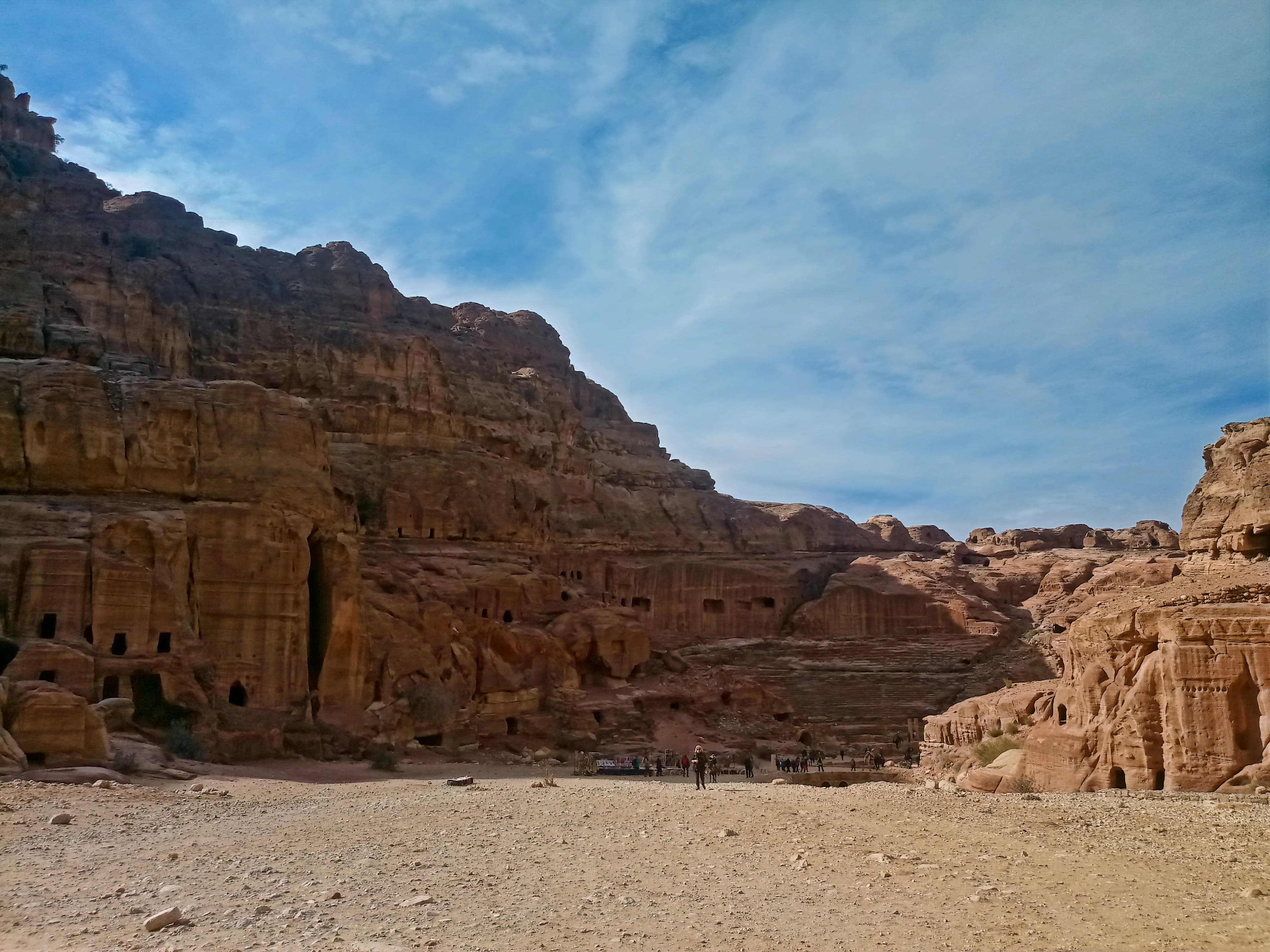 a group of people standing in the middle of a desert