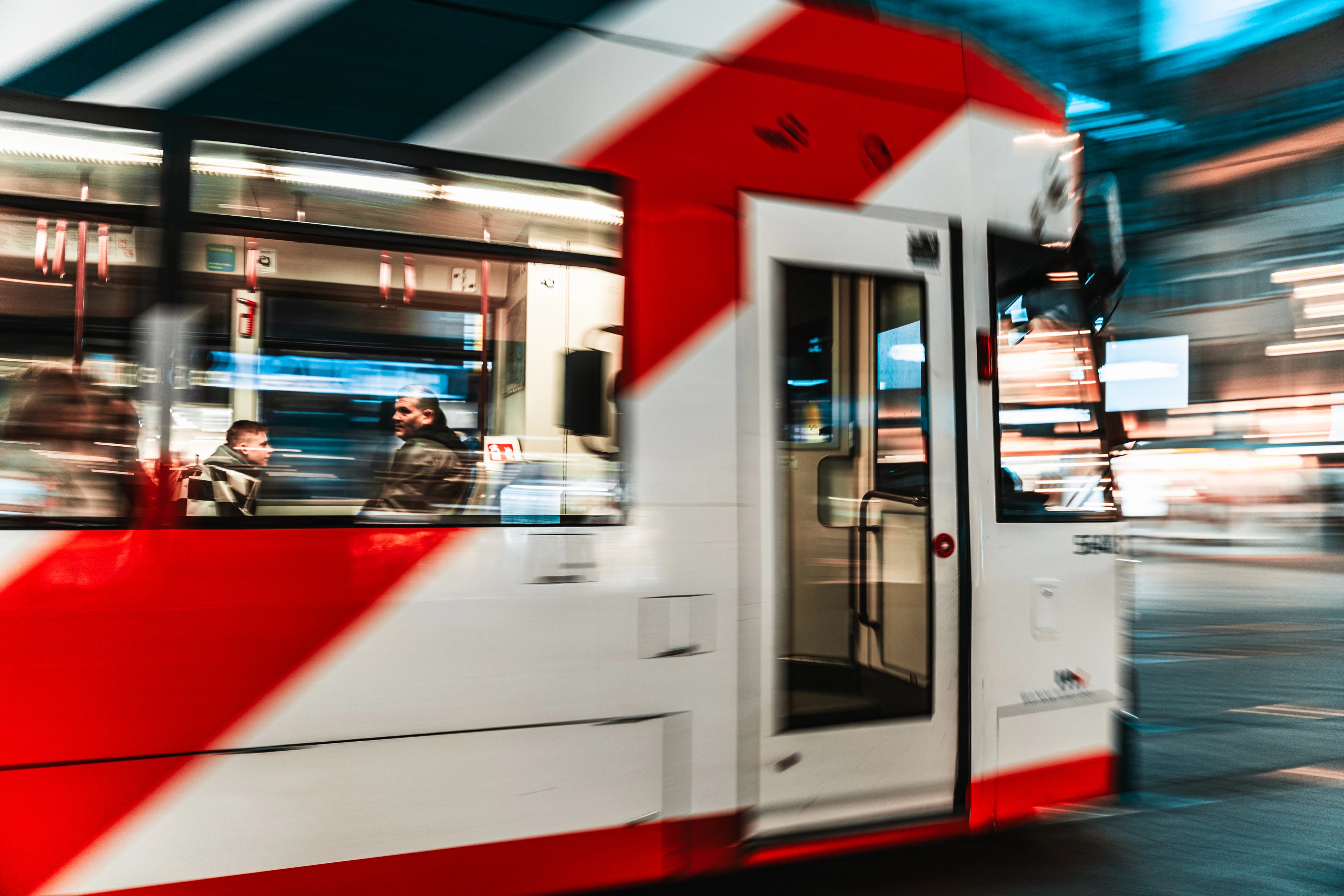 A moving tram with red and white stripes