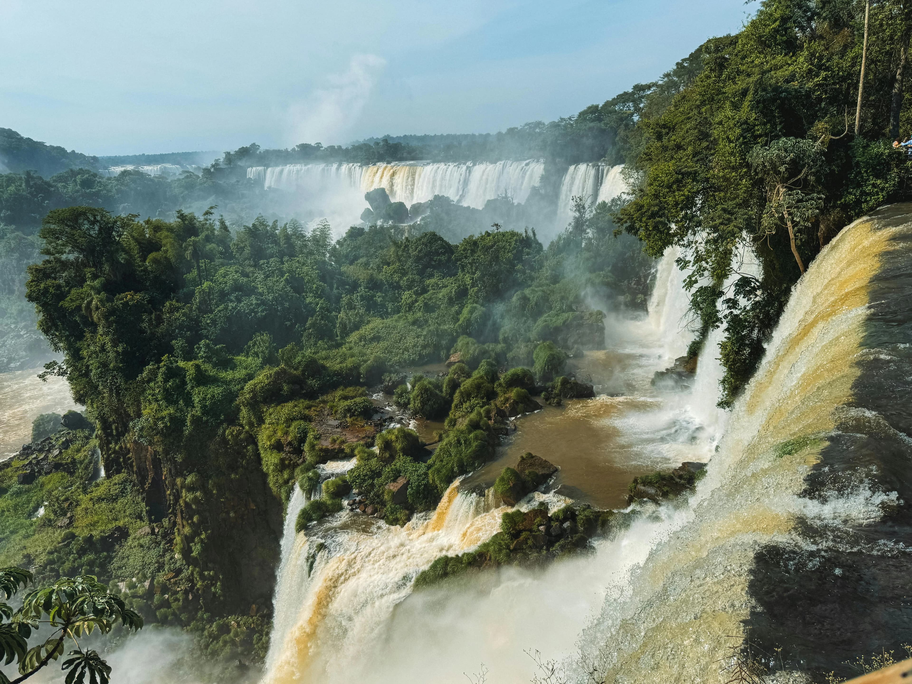 A large waterfall in the middle of a forest
