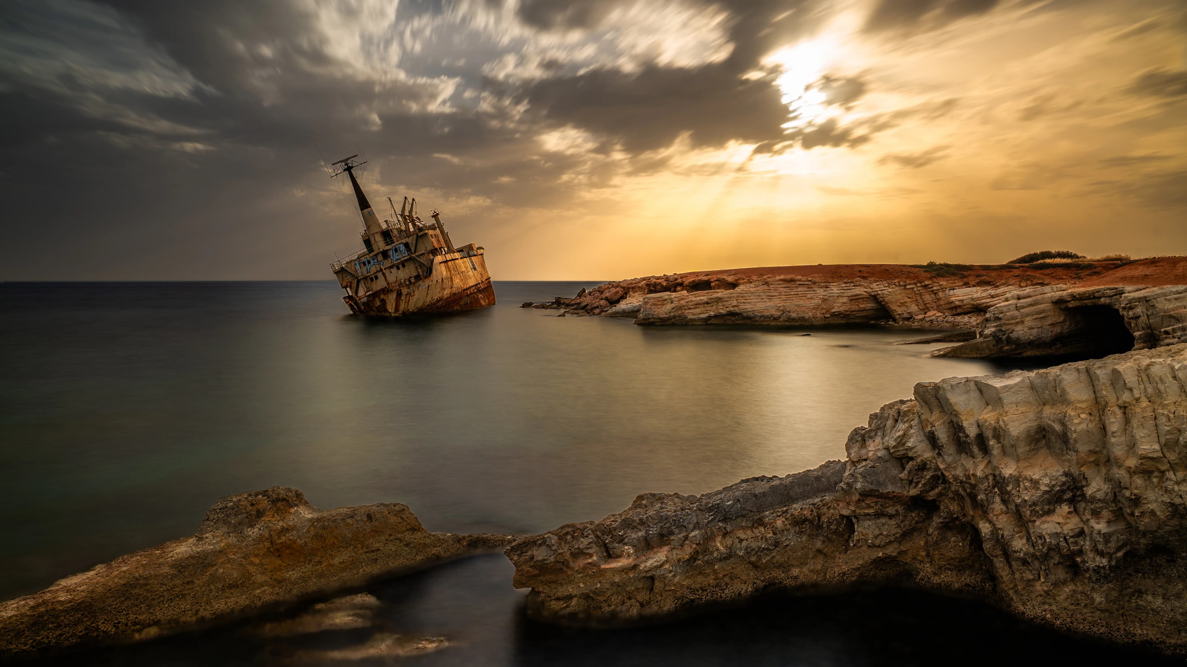 Sunlight streams onto a sunken ship.