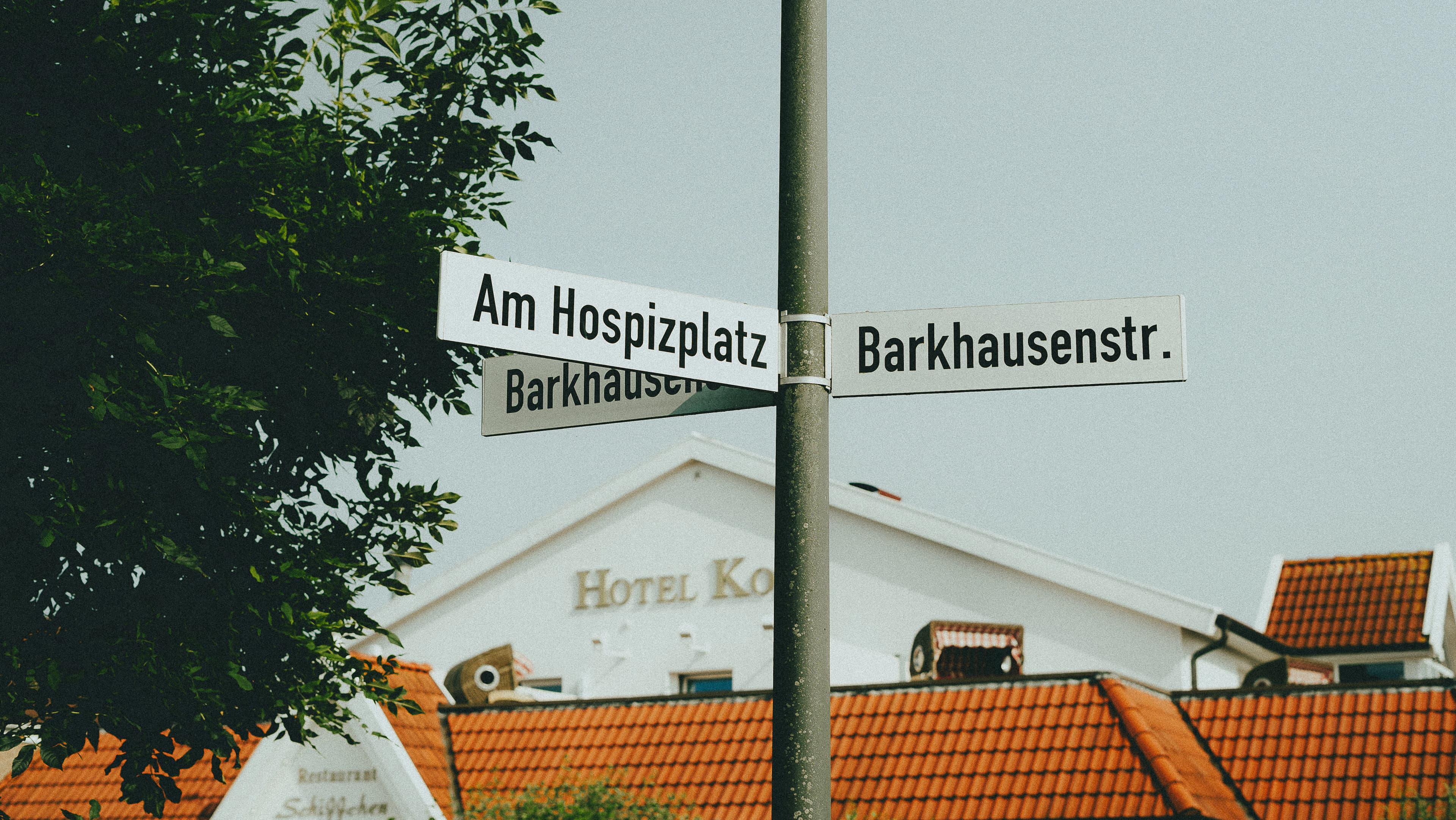 A street sign on a pole in front of a building