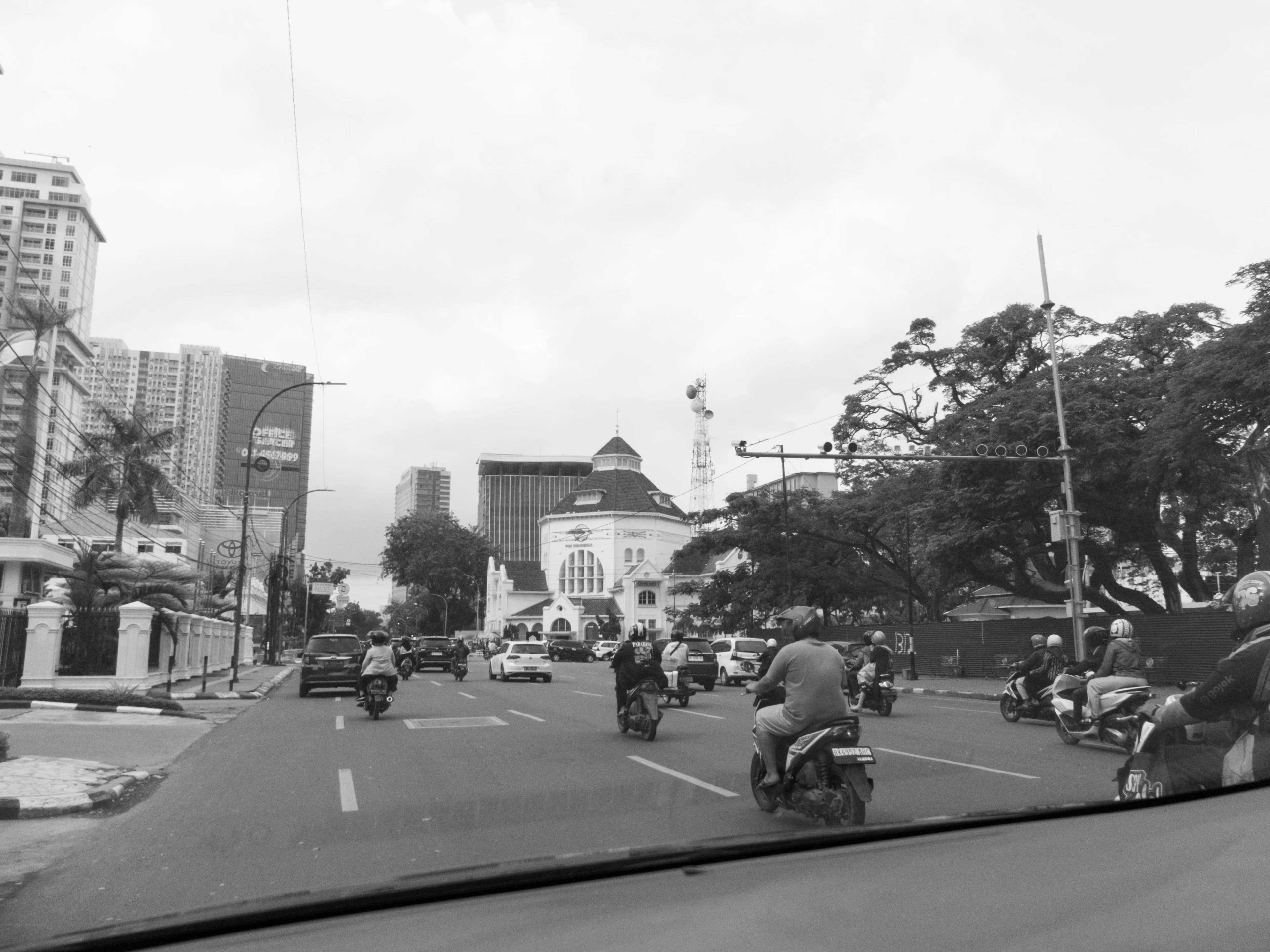a group of people riding motorcycles down a street