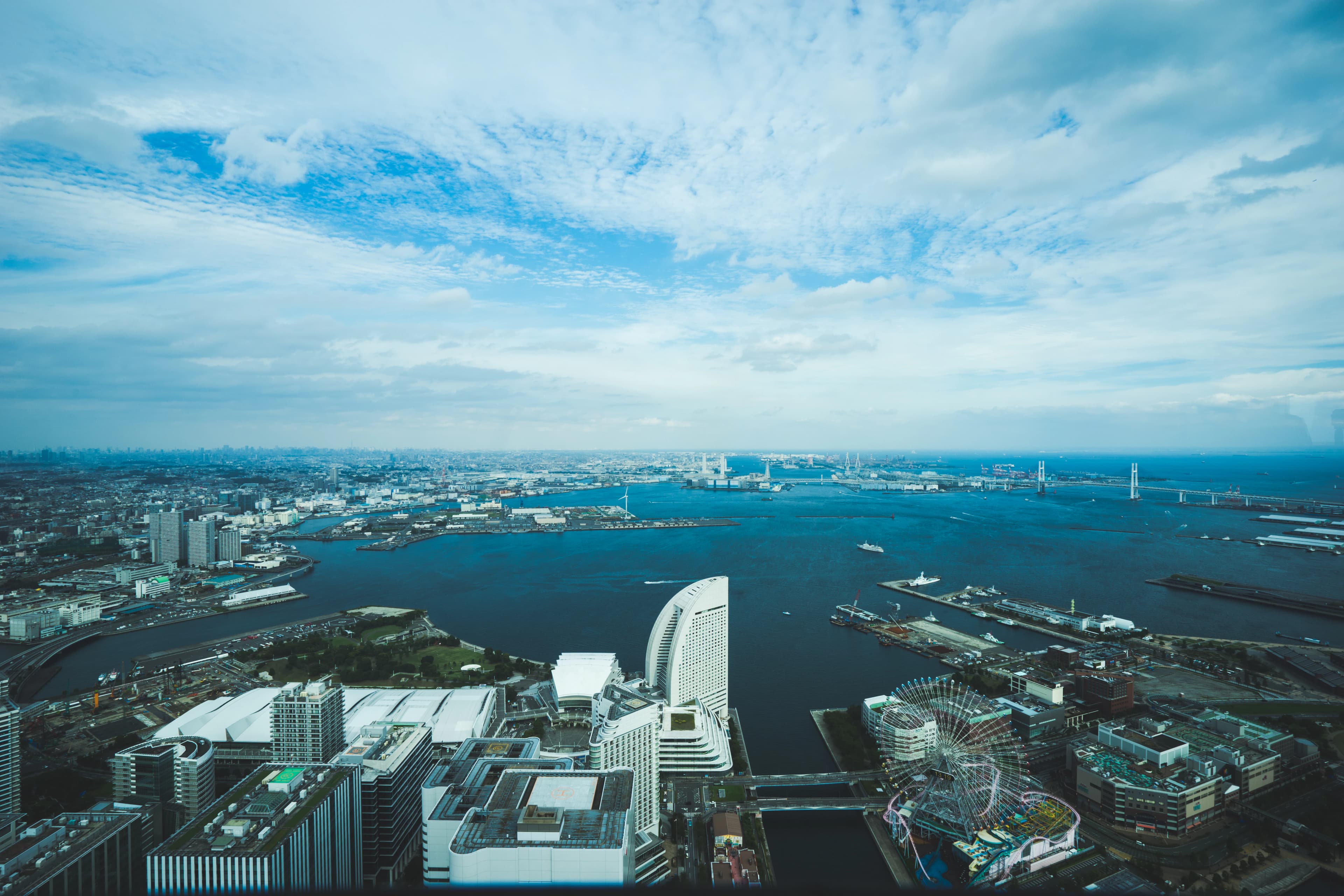 bird's eye view of city beside wide body of water during daytime