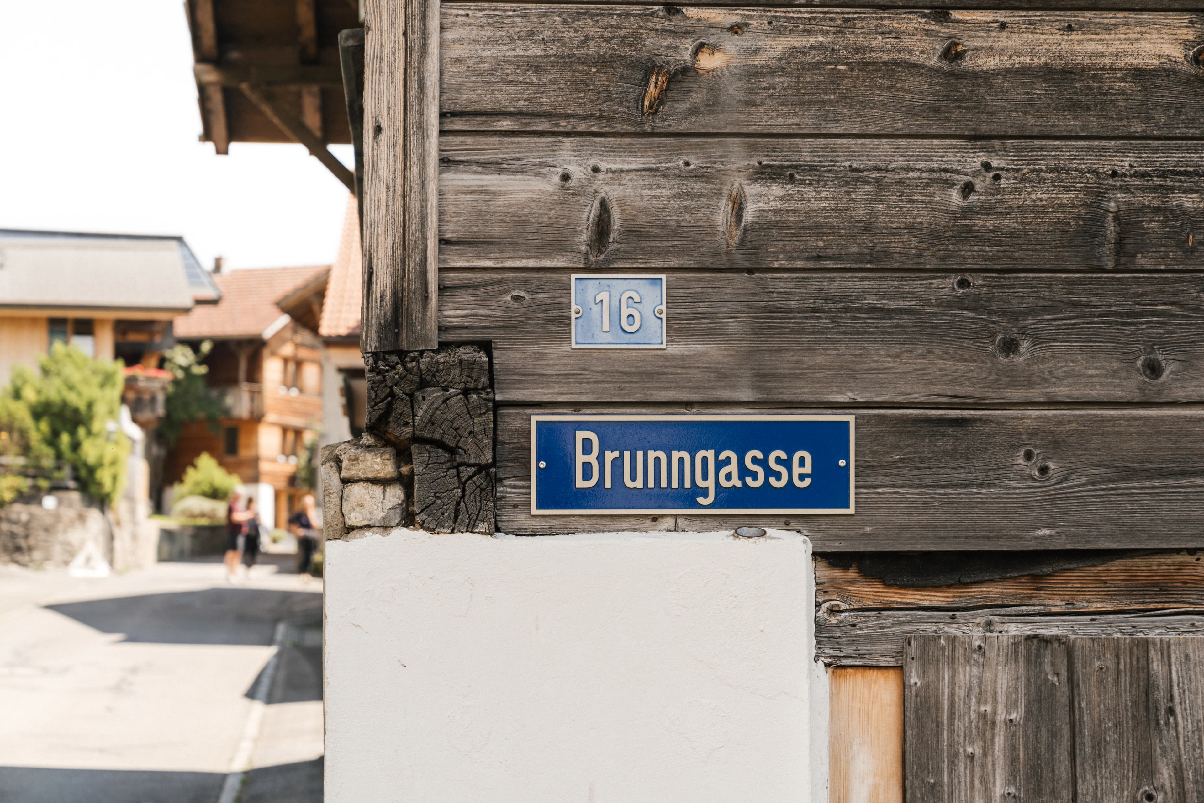 Street sign for brunngasse on a wooden building