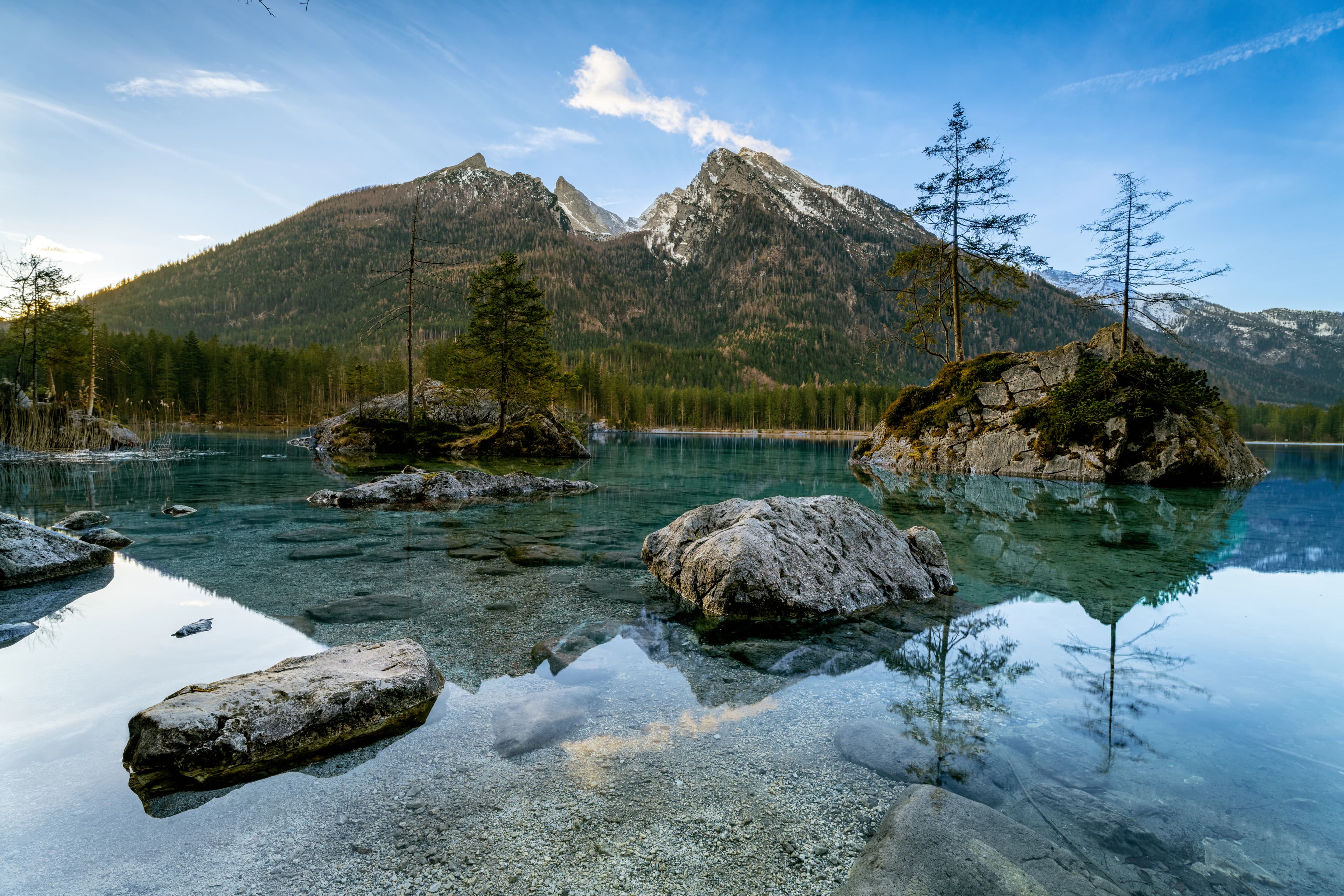 a mountain range is reflected in the water of a lake