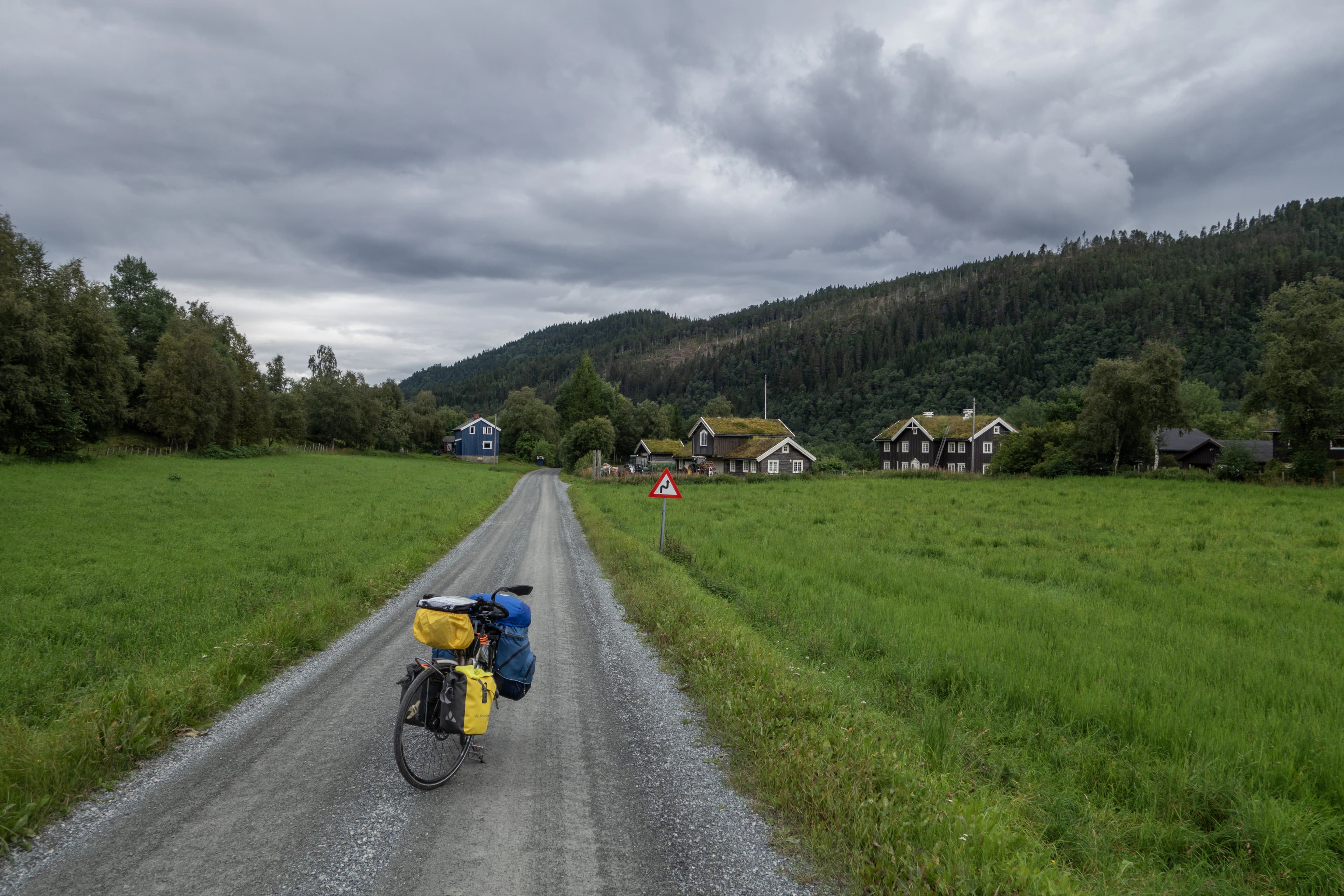 A person riding a bike down a dirt road