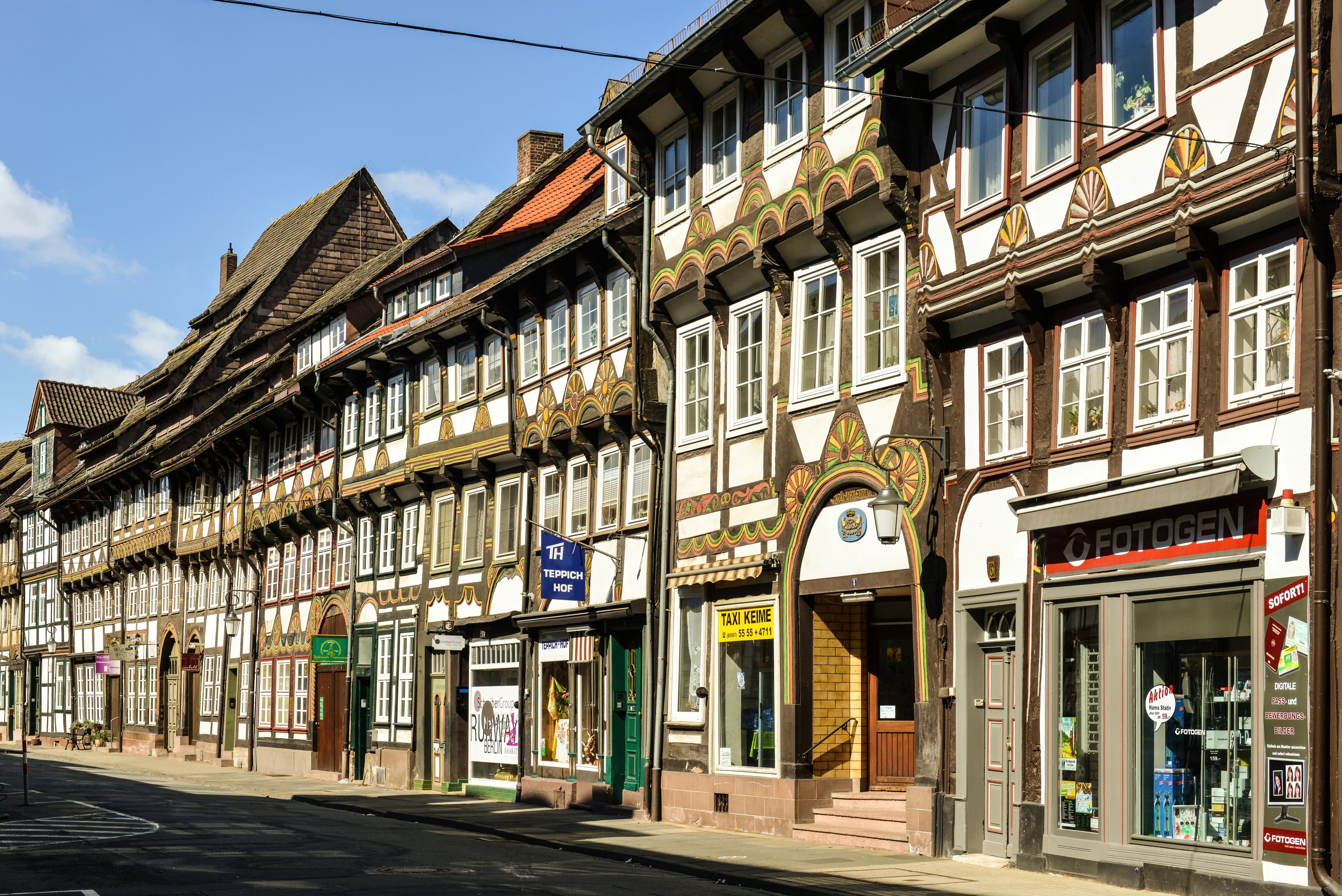 Row of historic half-timbered houses on a street.