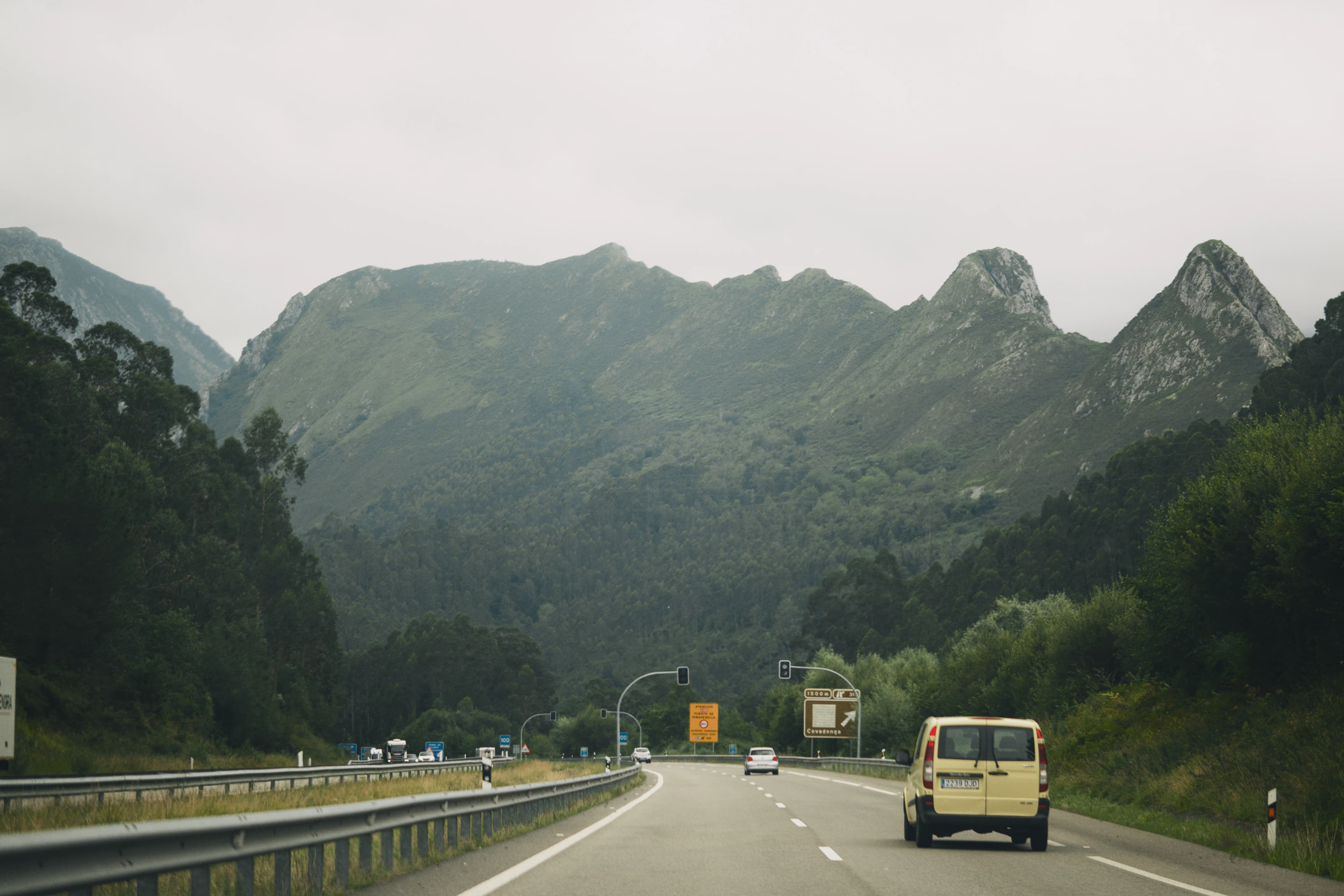 A van is driving down a mountain road