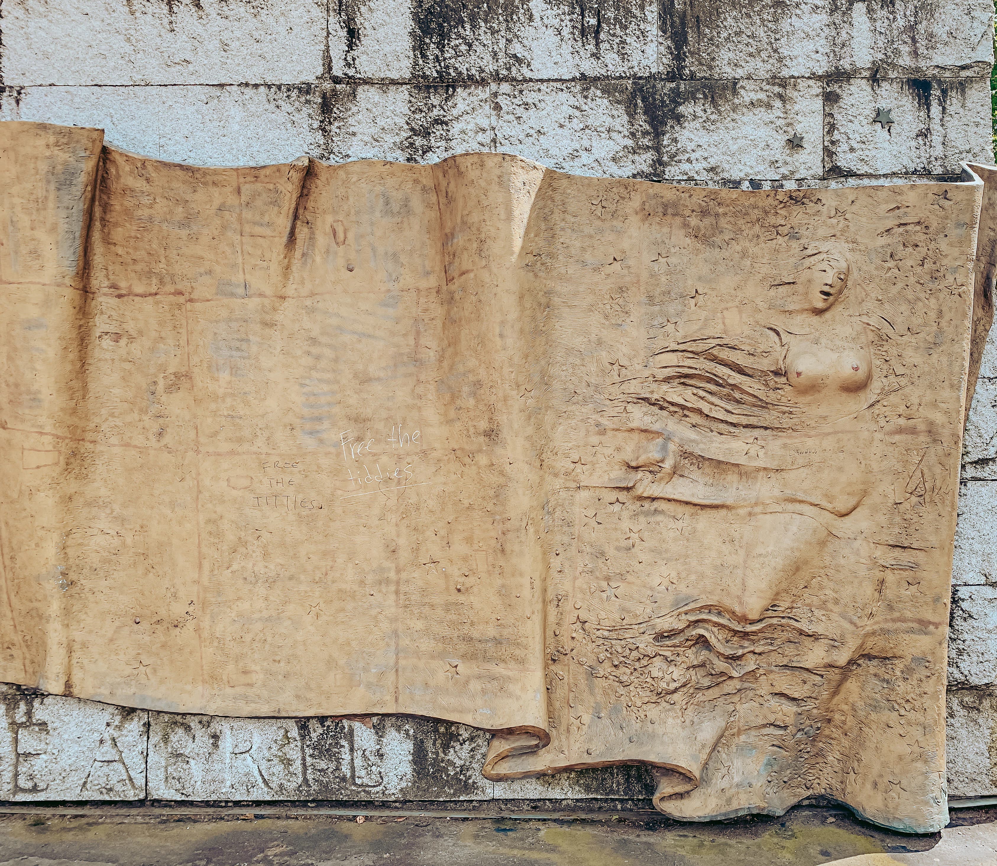 a stone carving of a man and woman