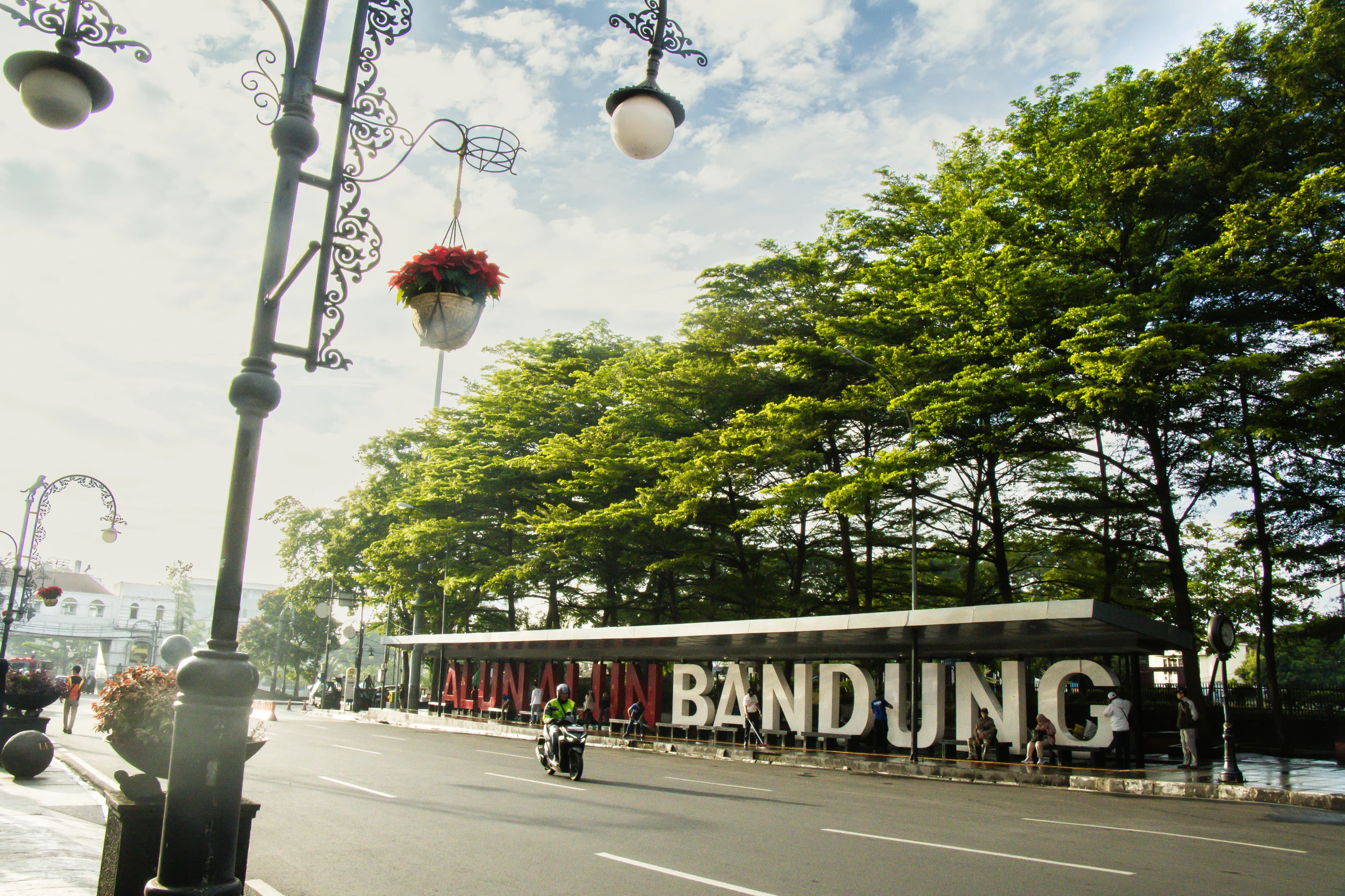 Bandung city sign with trees and decorative lamps.