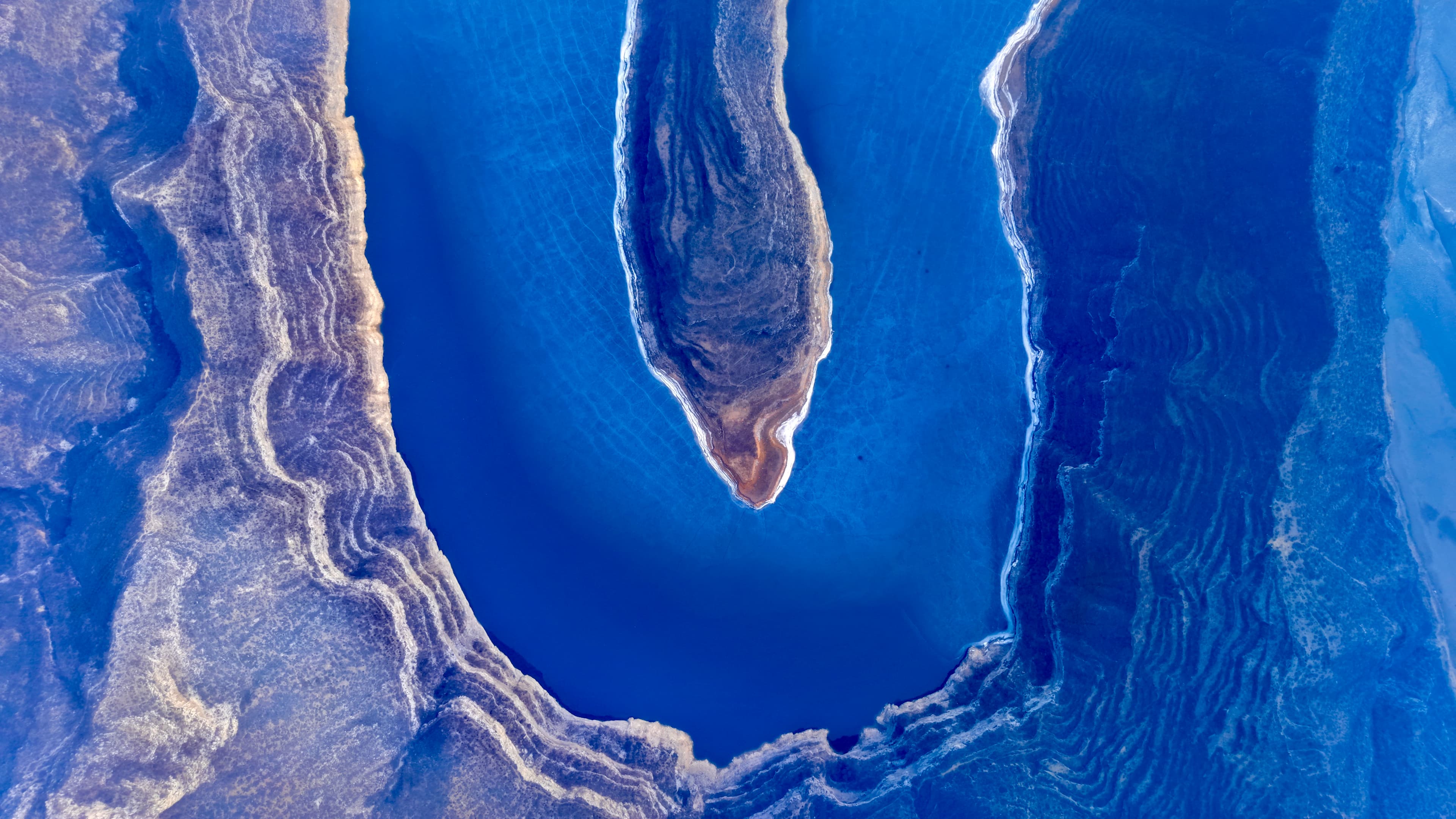 A blue lake with unique geological formations.