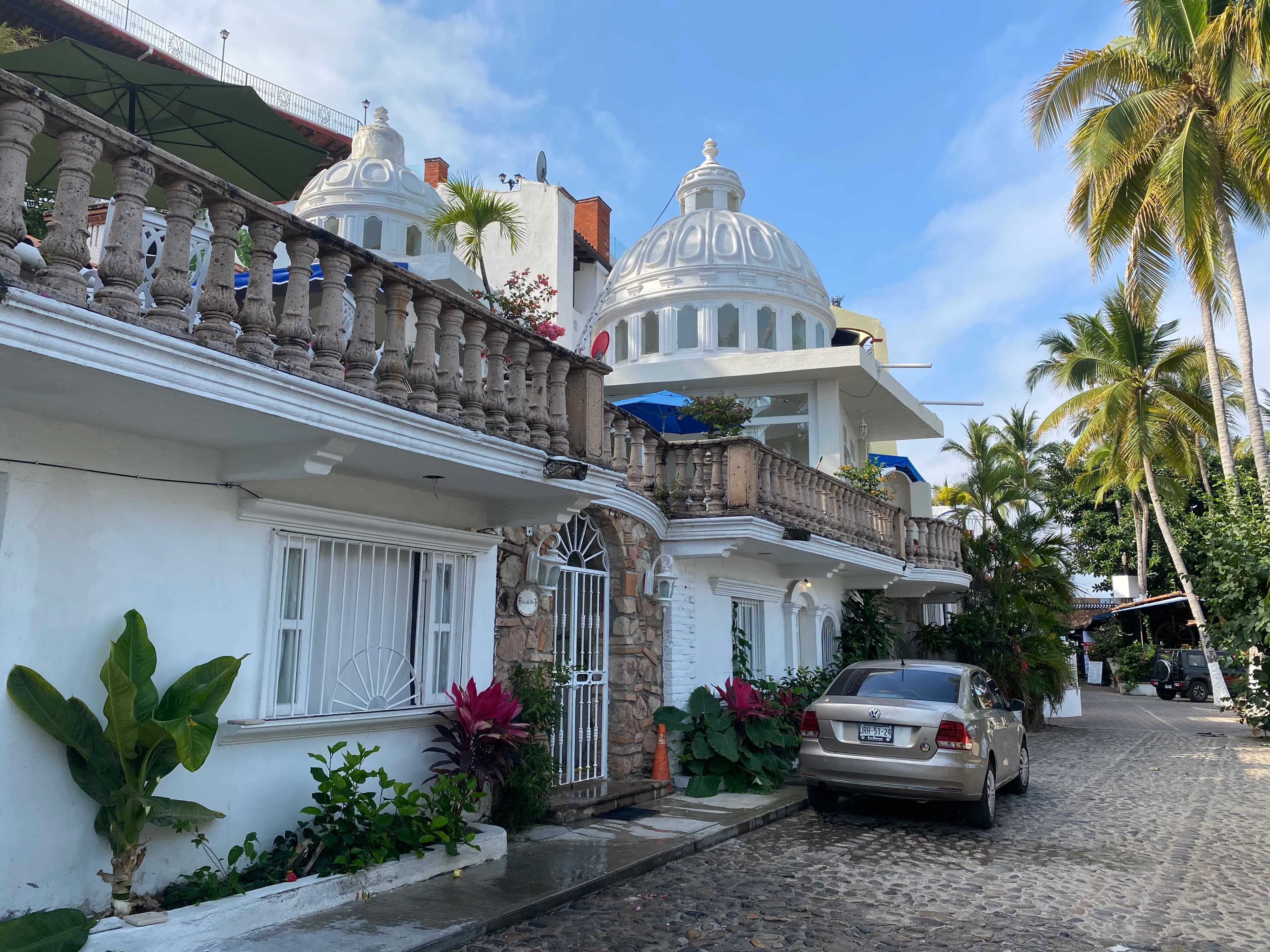 a car parked in front of a white building