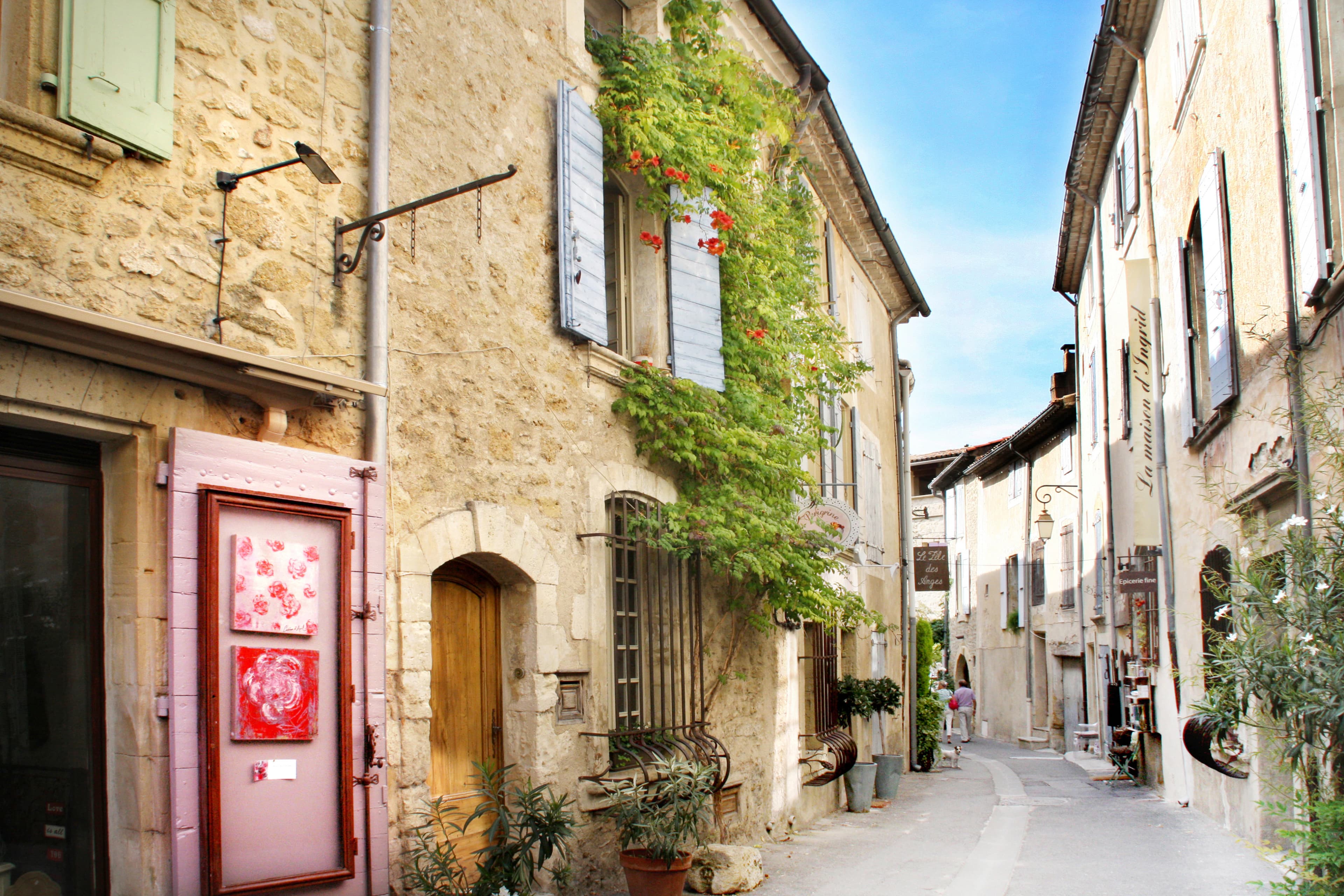 Charming european street with stone buildings and greenery.