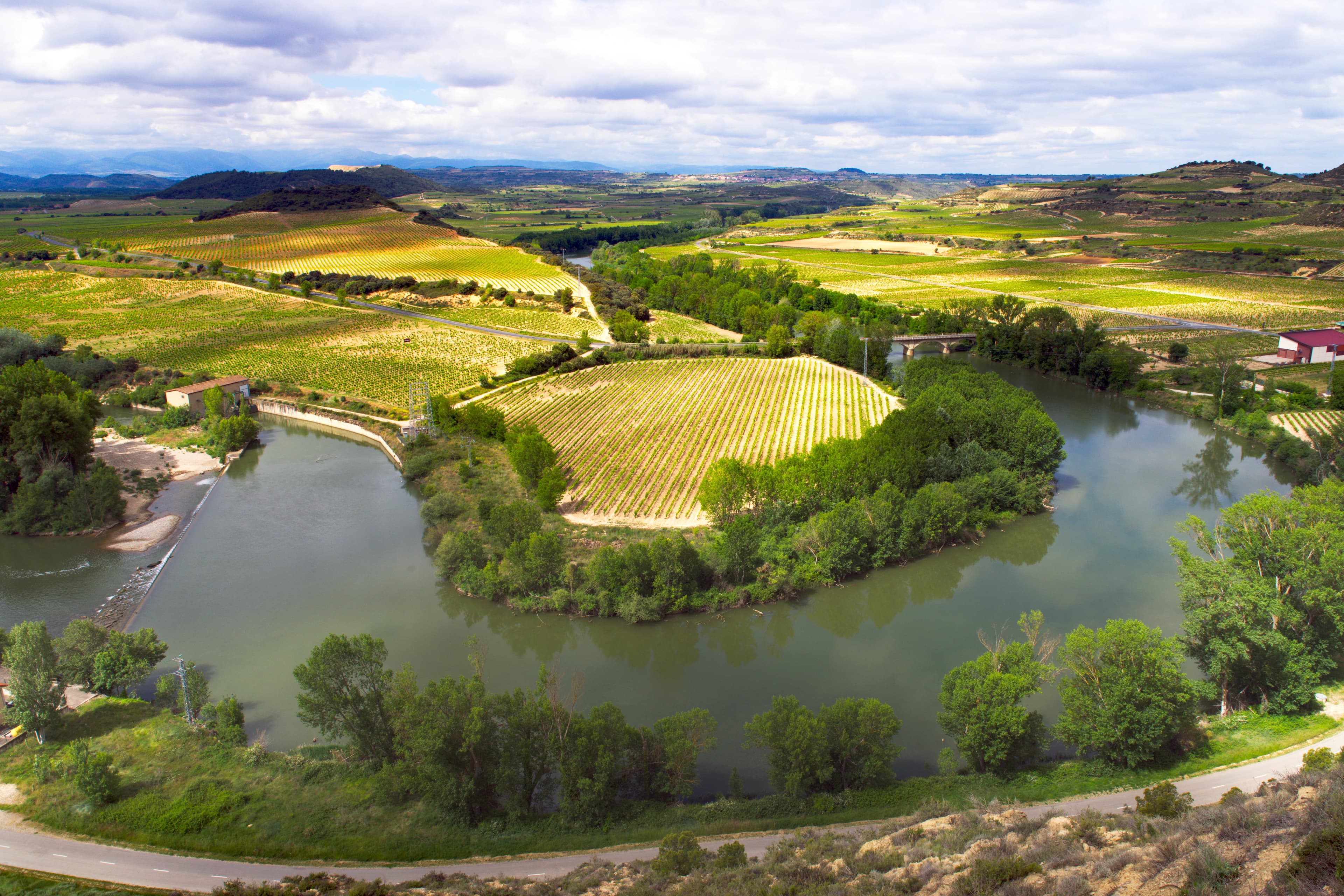 A river running through a lush green countryside