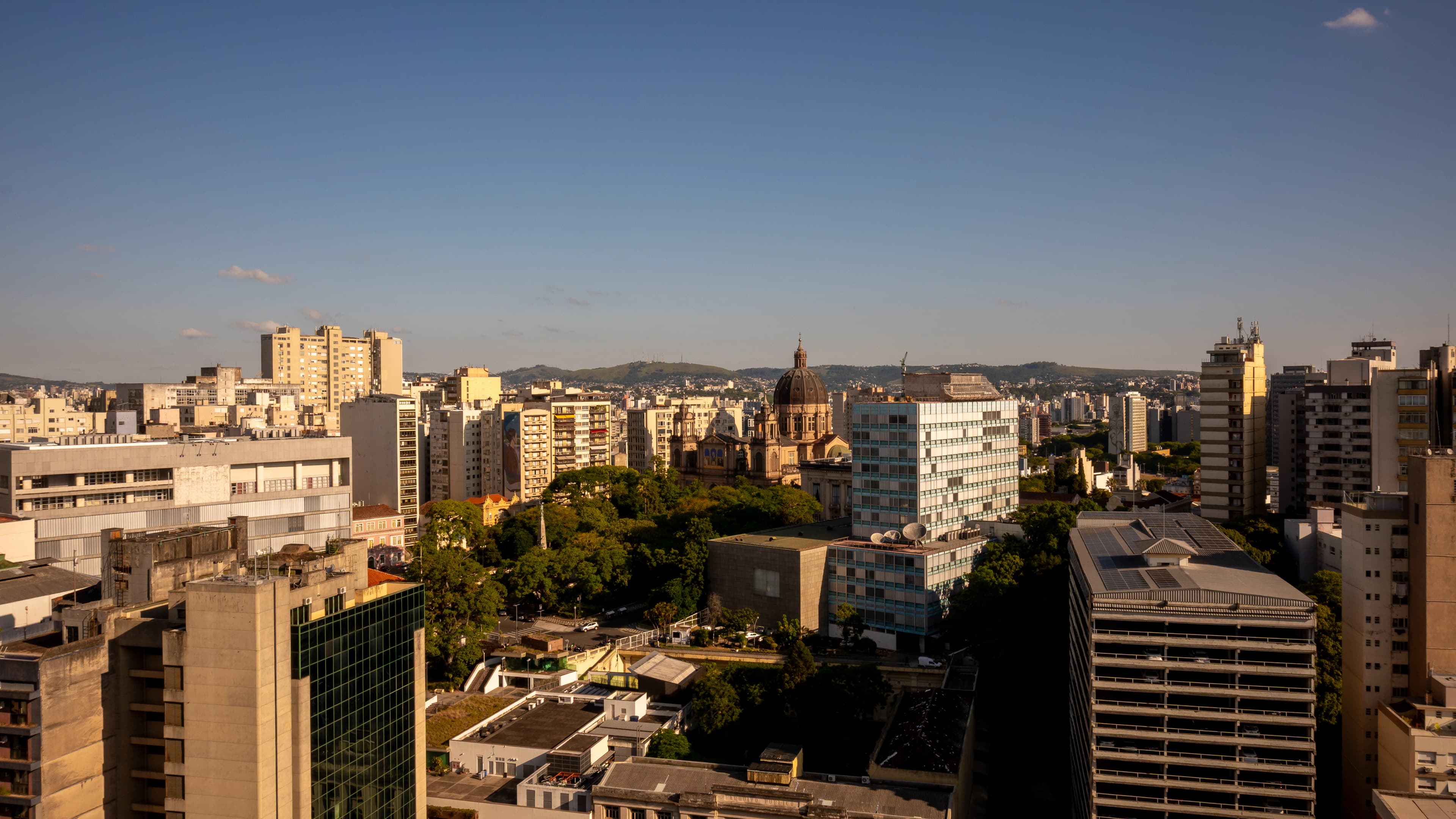 City skyline with buildings and a dome under clear sky