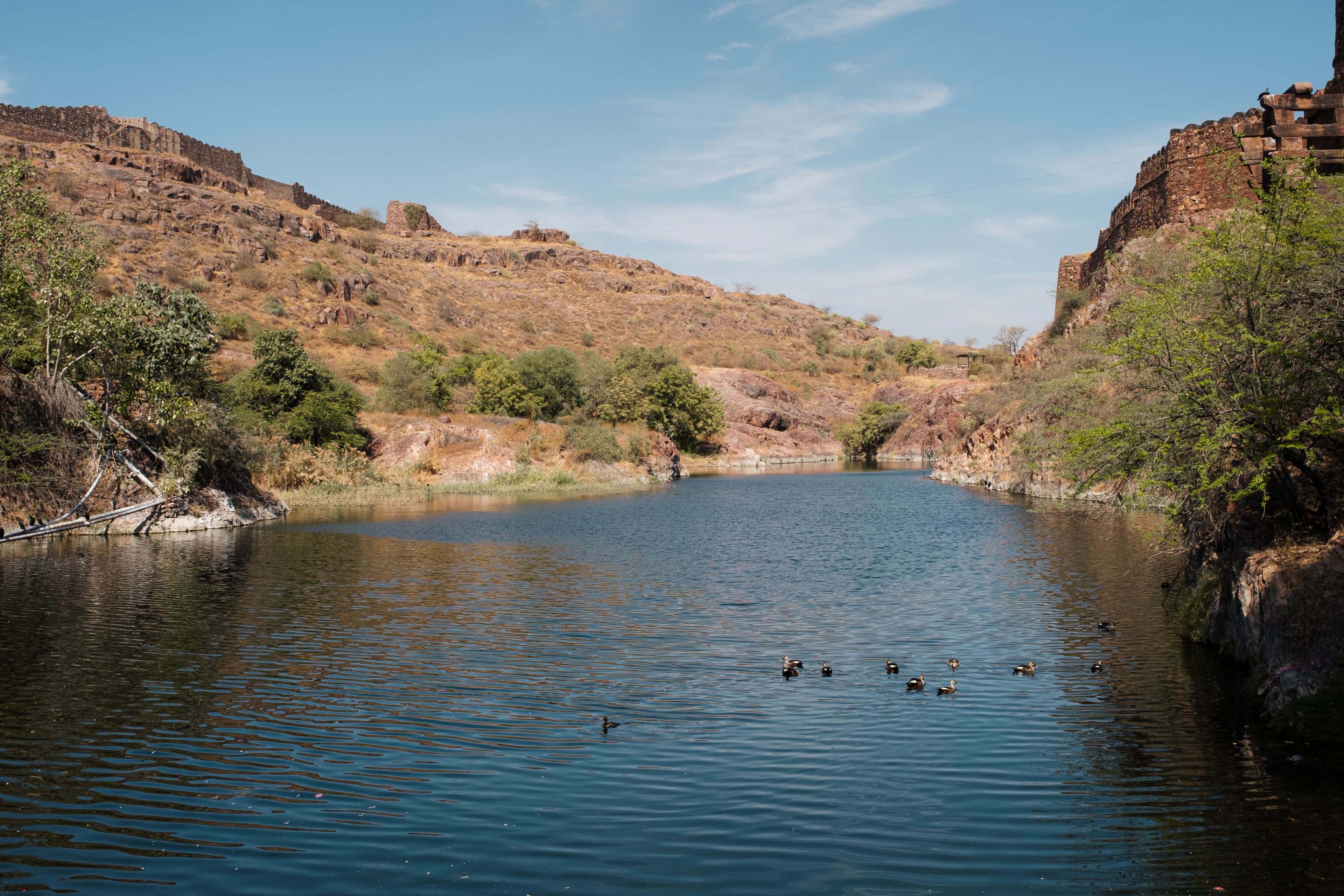 A tranquil lake nestled between rugged hills.