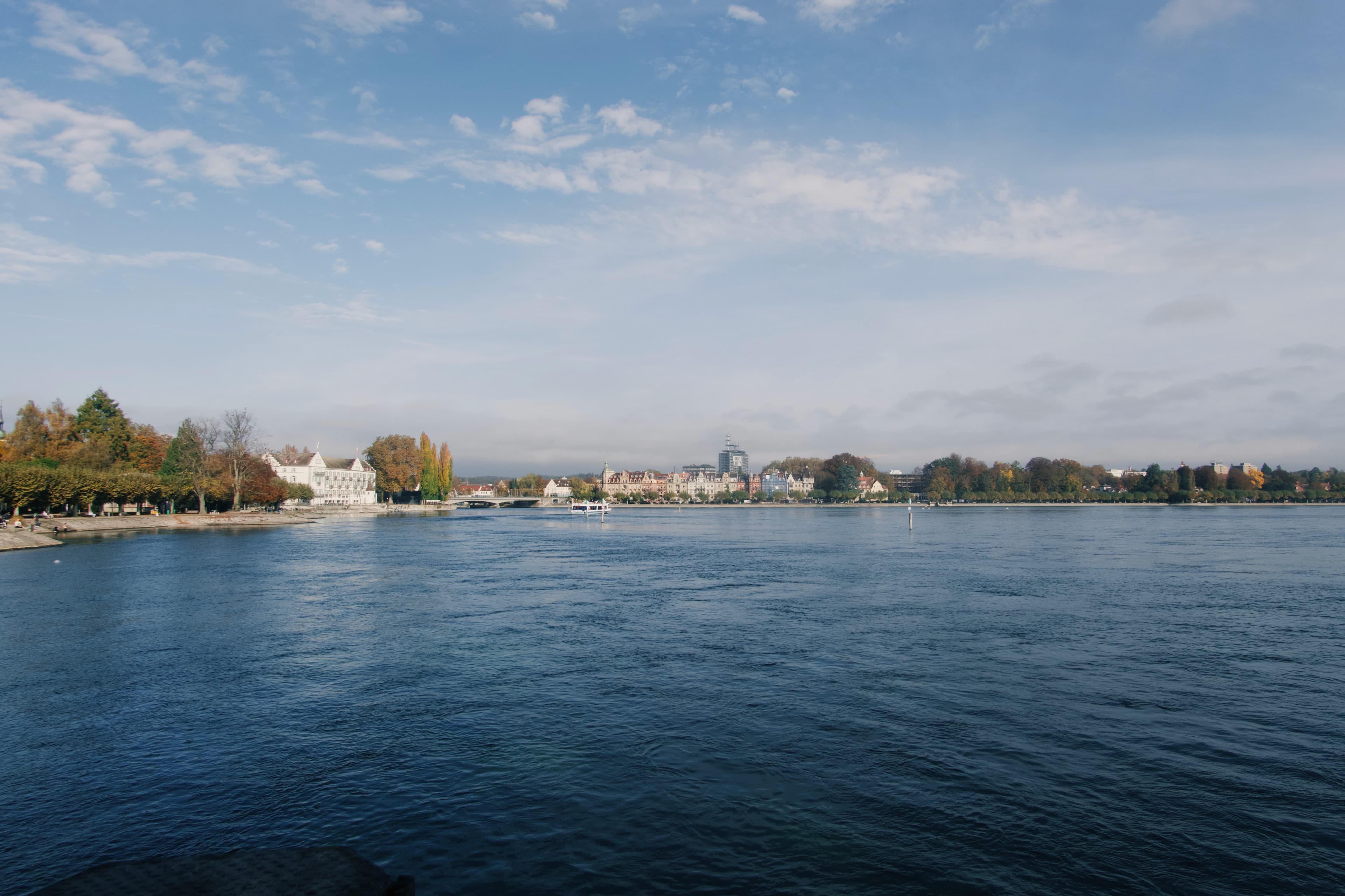 Waterfront view of a town under a blue sky.