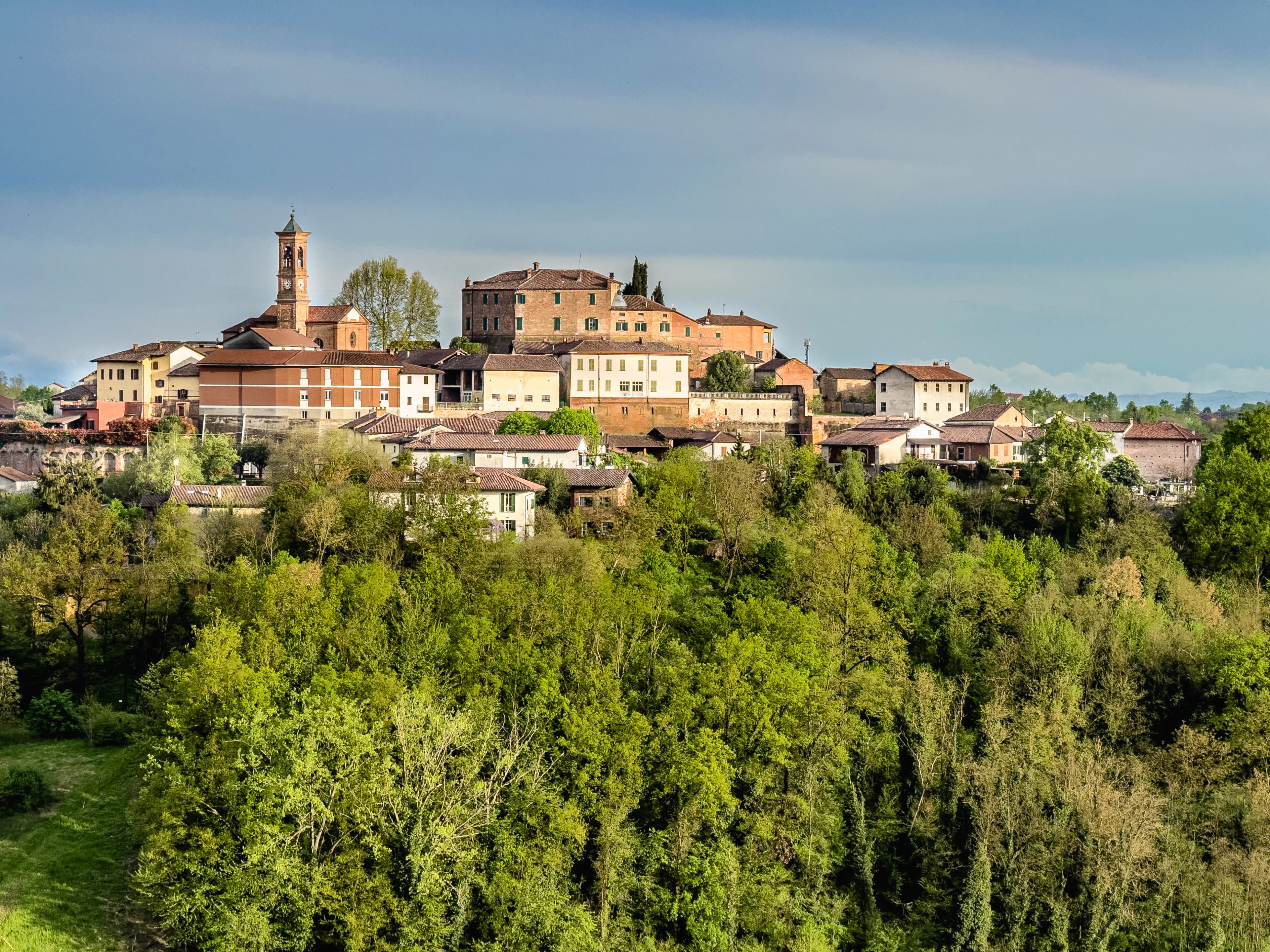 A scenic view of a town atop a hill.