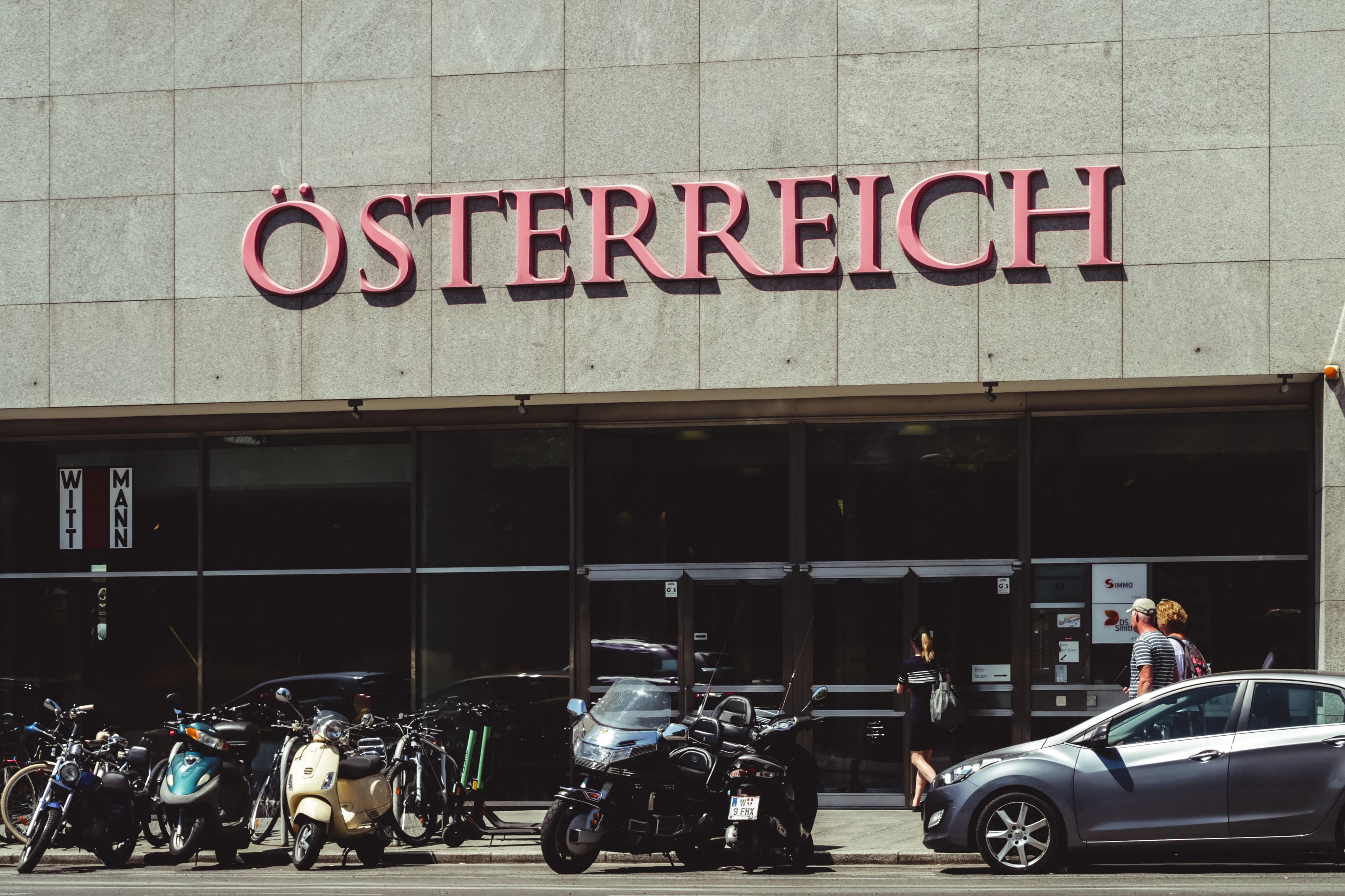 black and white motorcycle parked beside the building