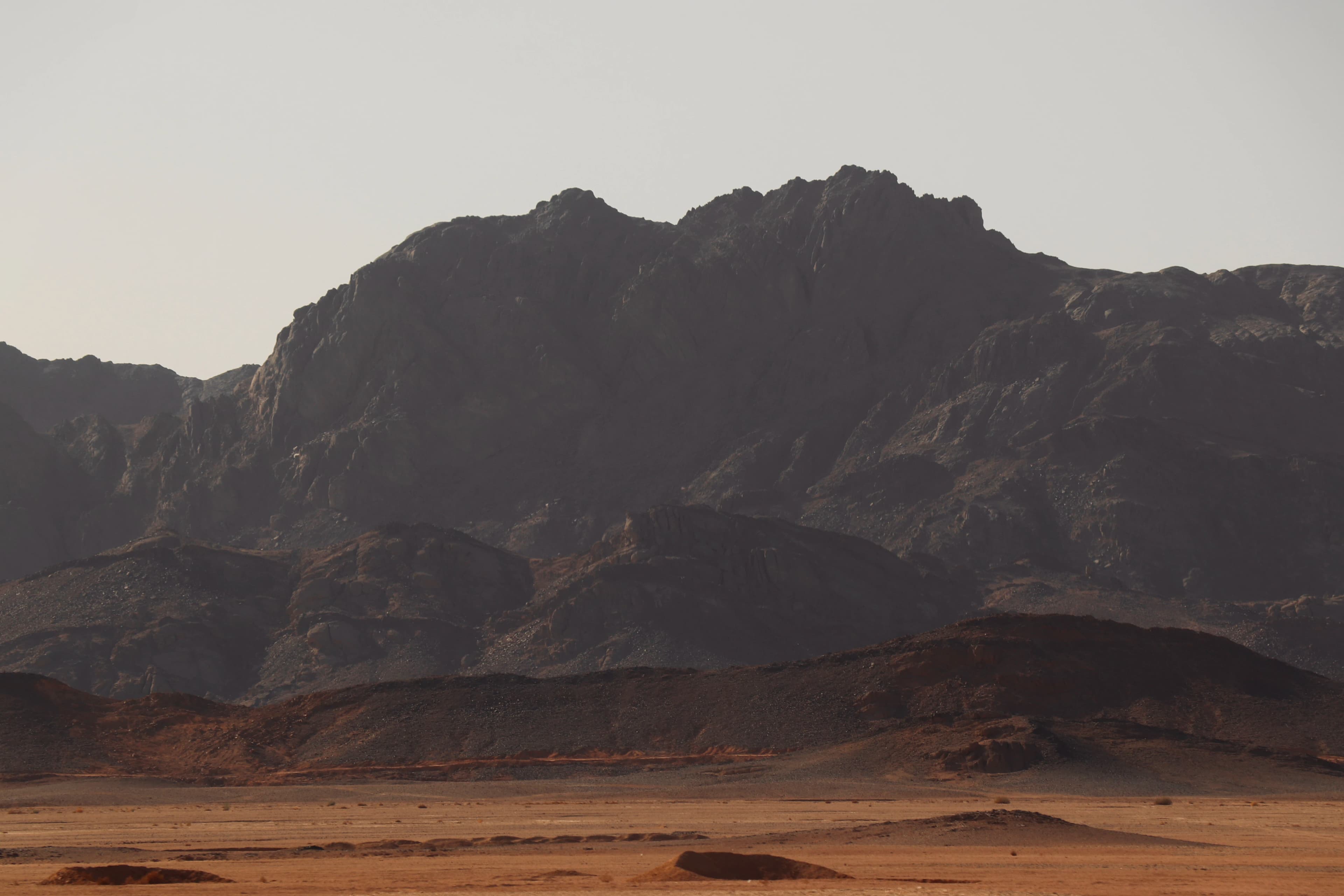 Jagged mountain range under a hazy sky