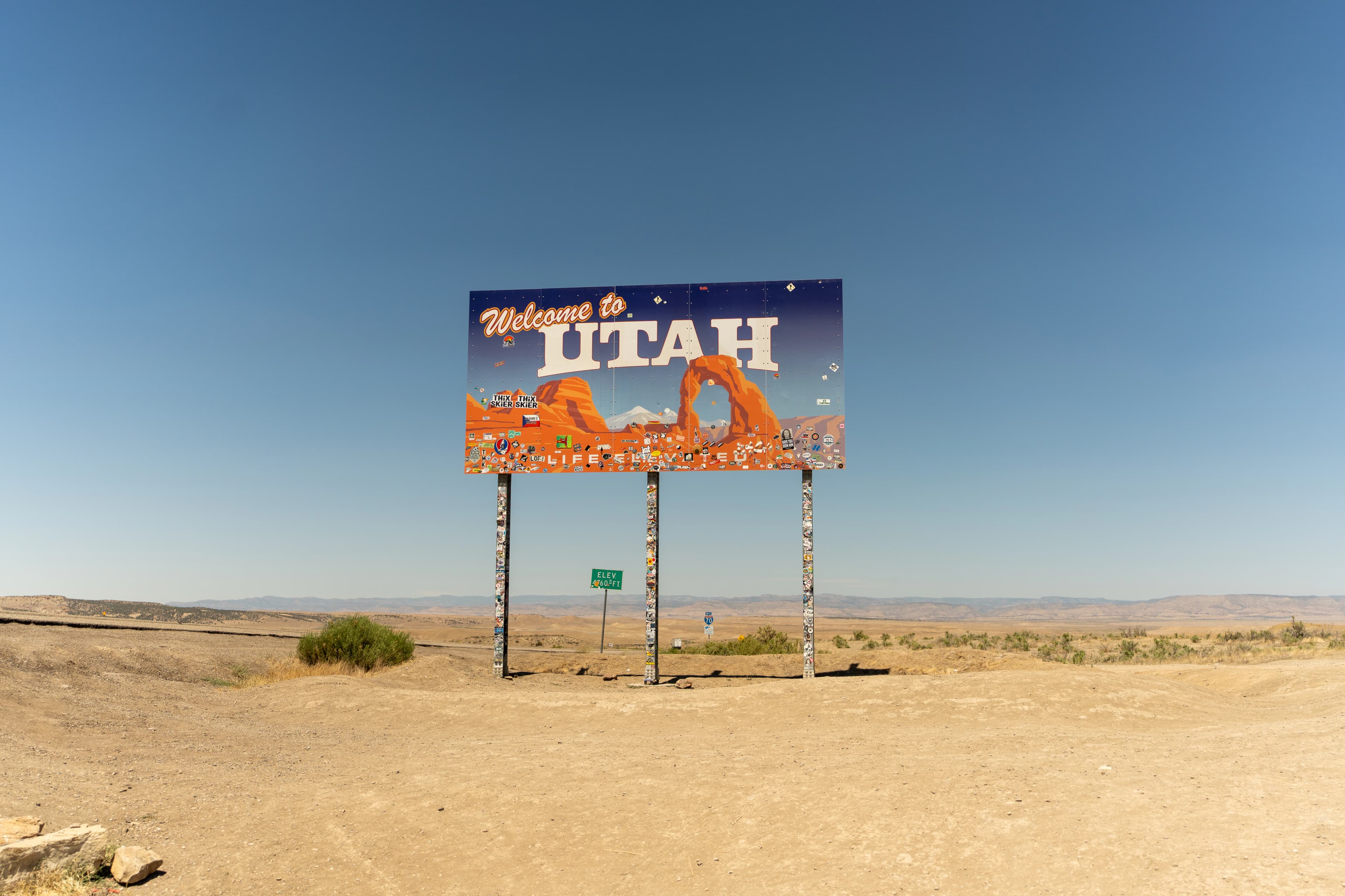 A large sign in the middle of a desert