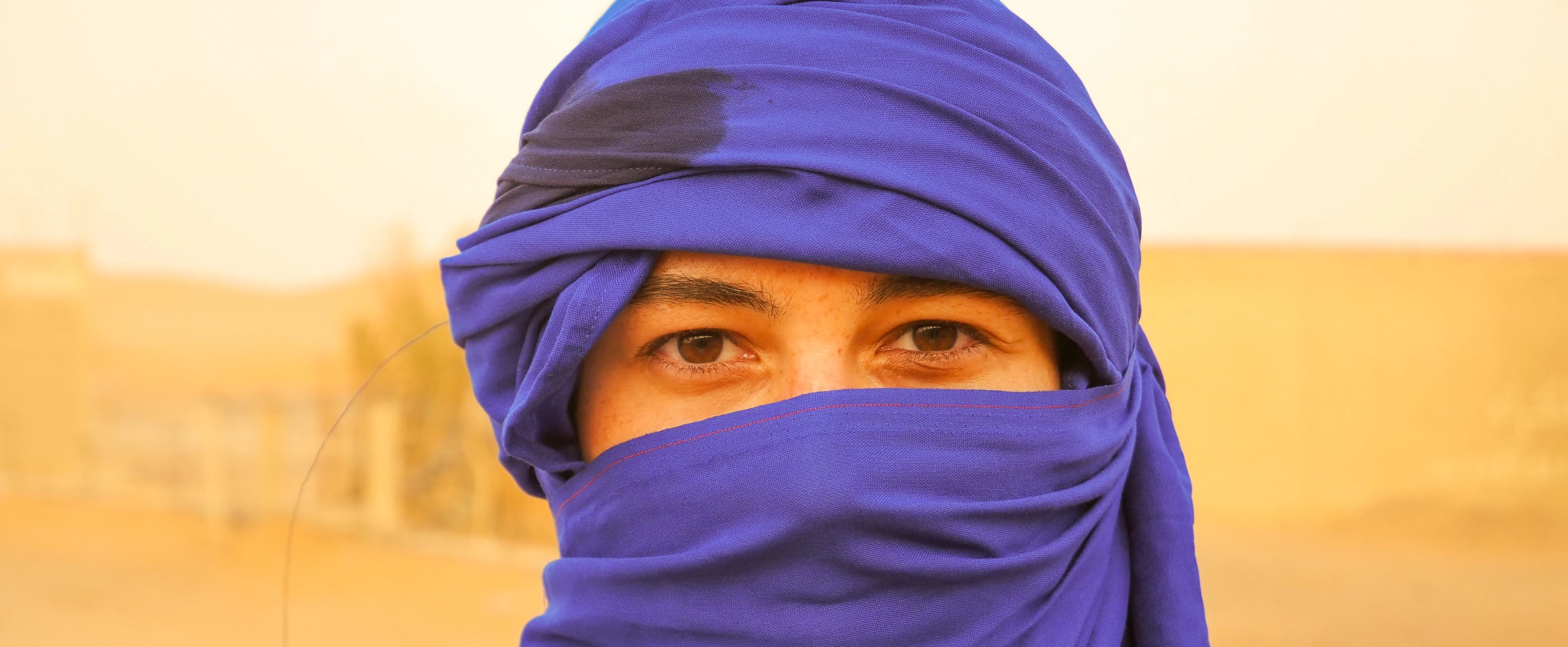 A person in a blue turban and face covering.