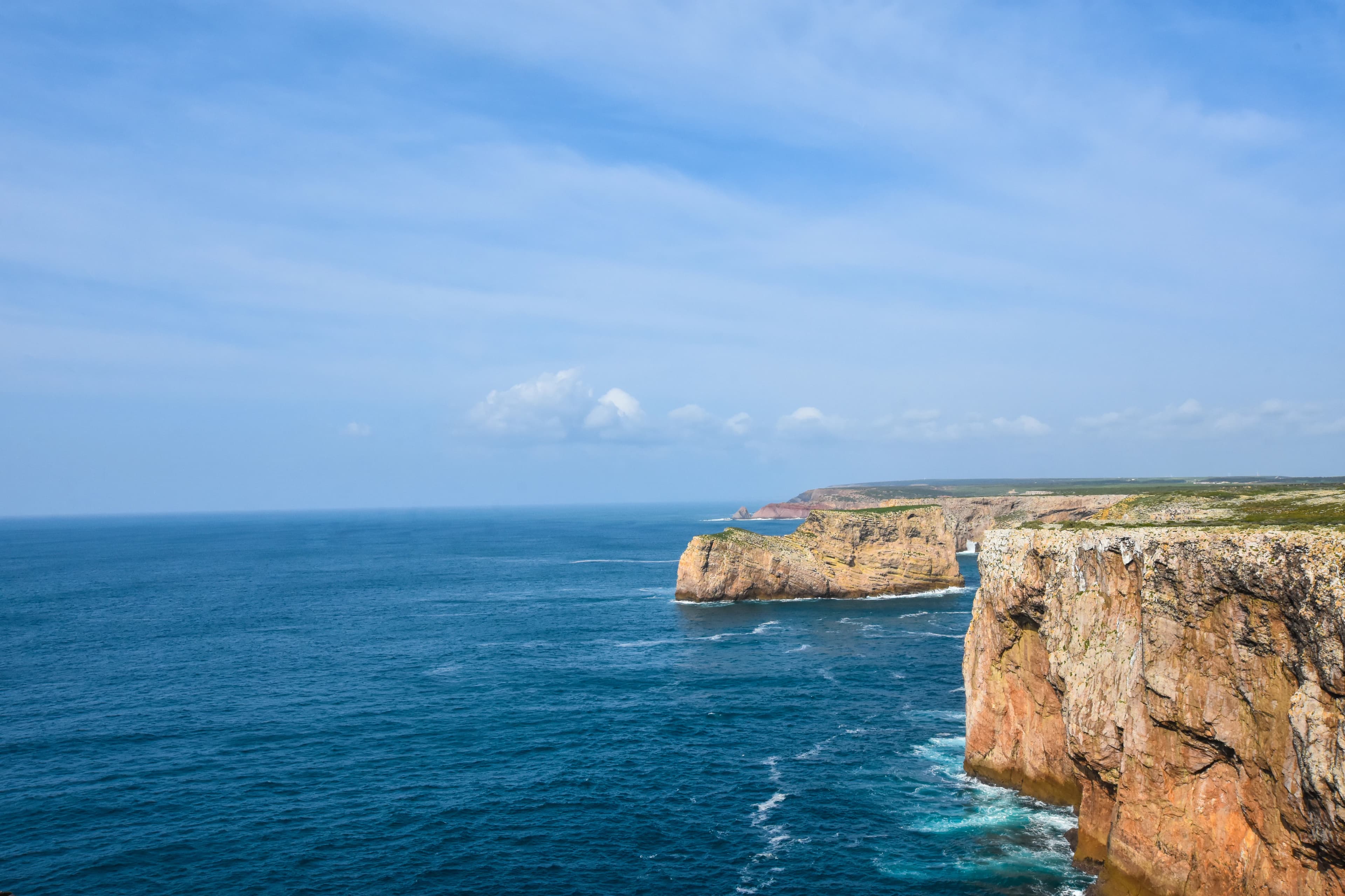 a cliff next to the ocean