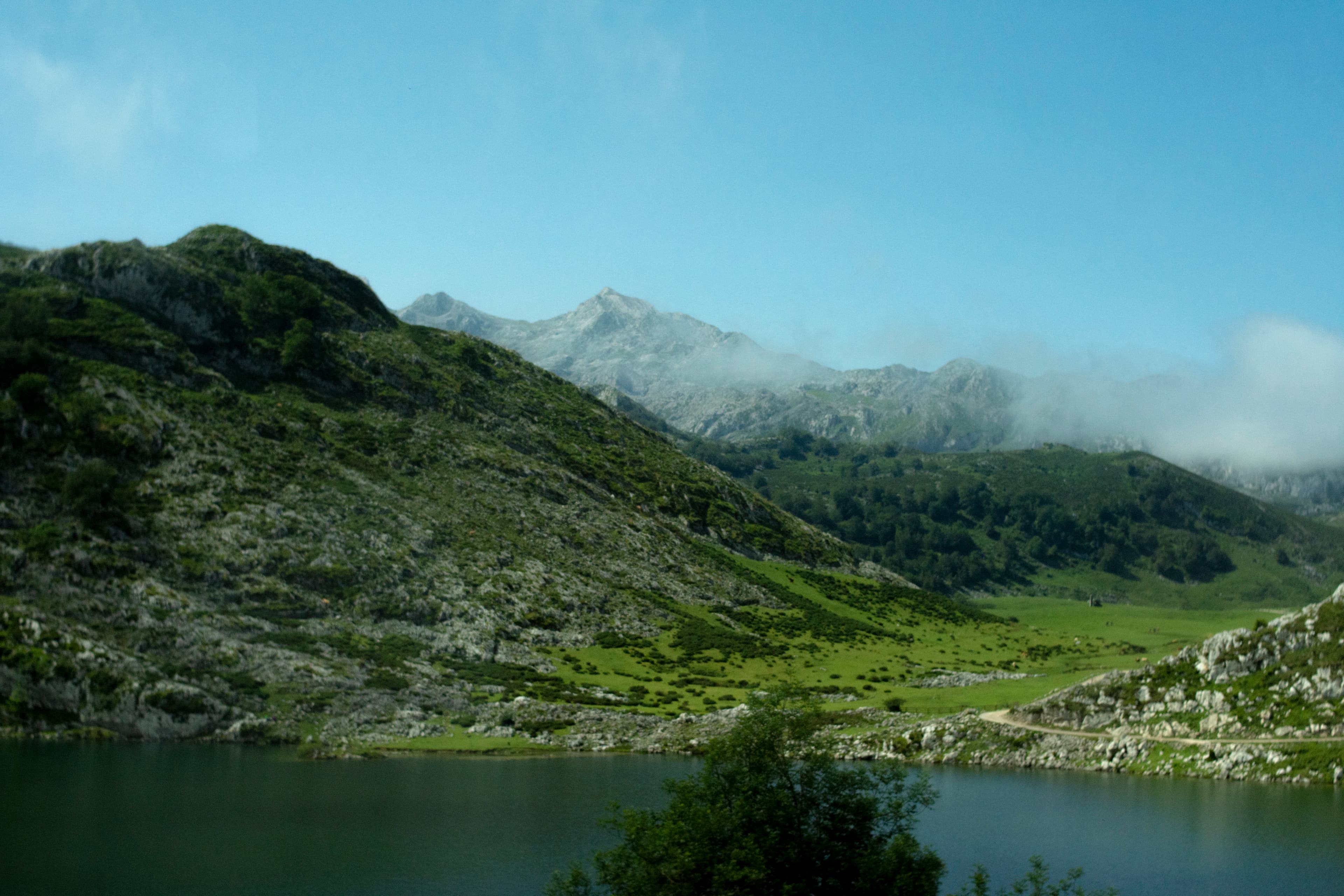 a view of a mountain range with a lake in the foreground
