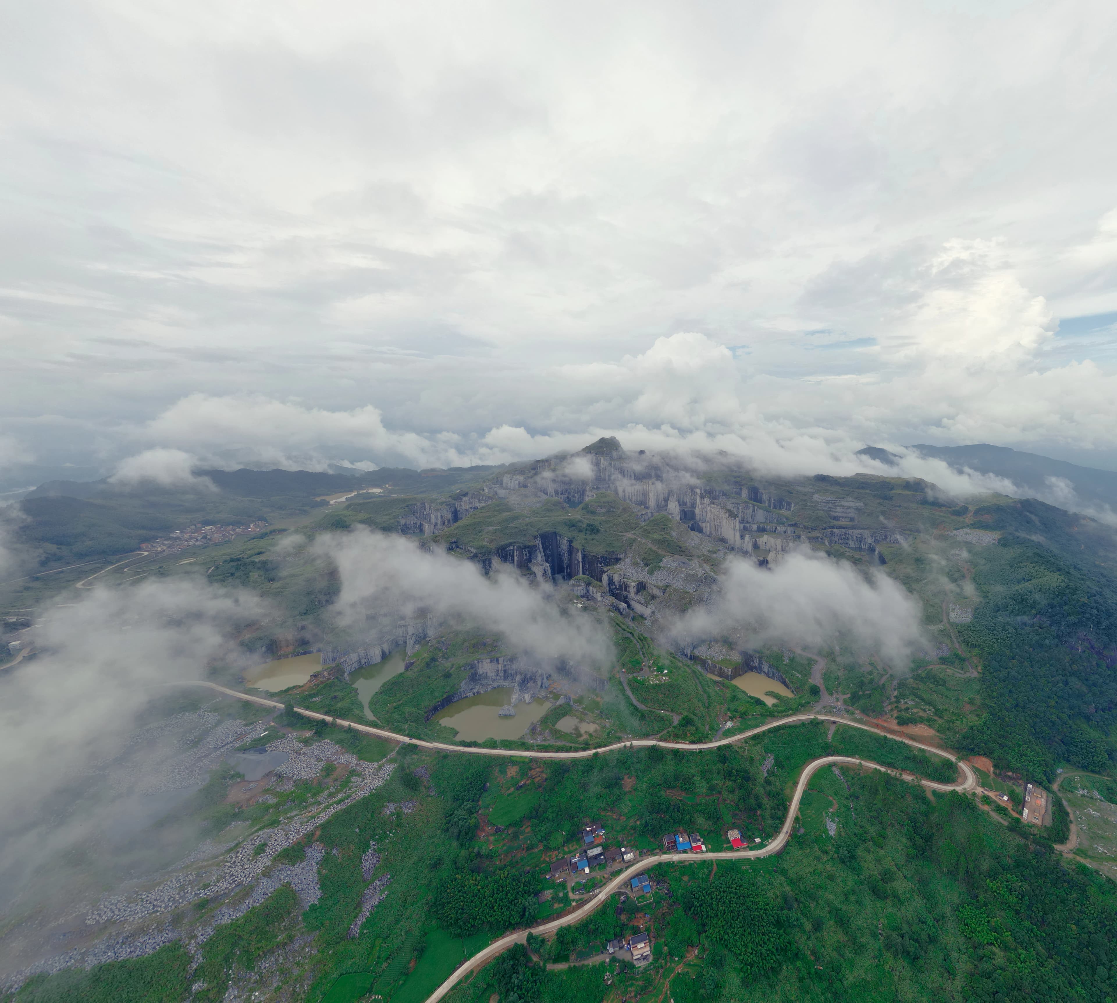 Mountain landscape shrouded in low clouds and mist