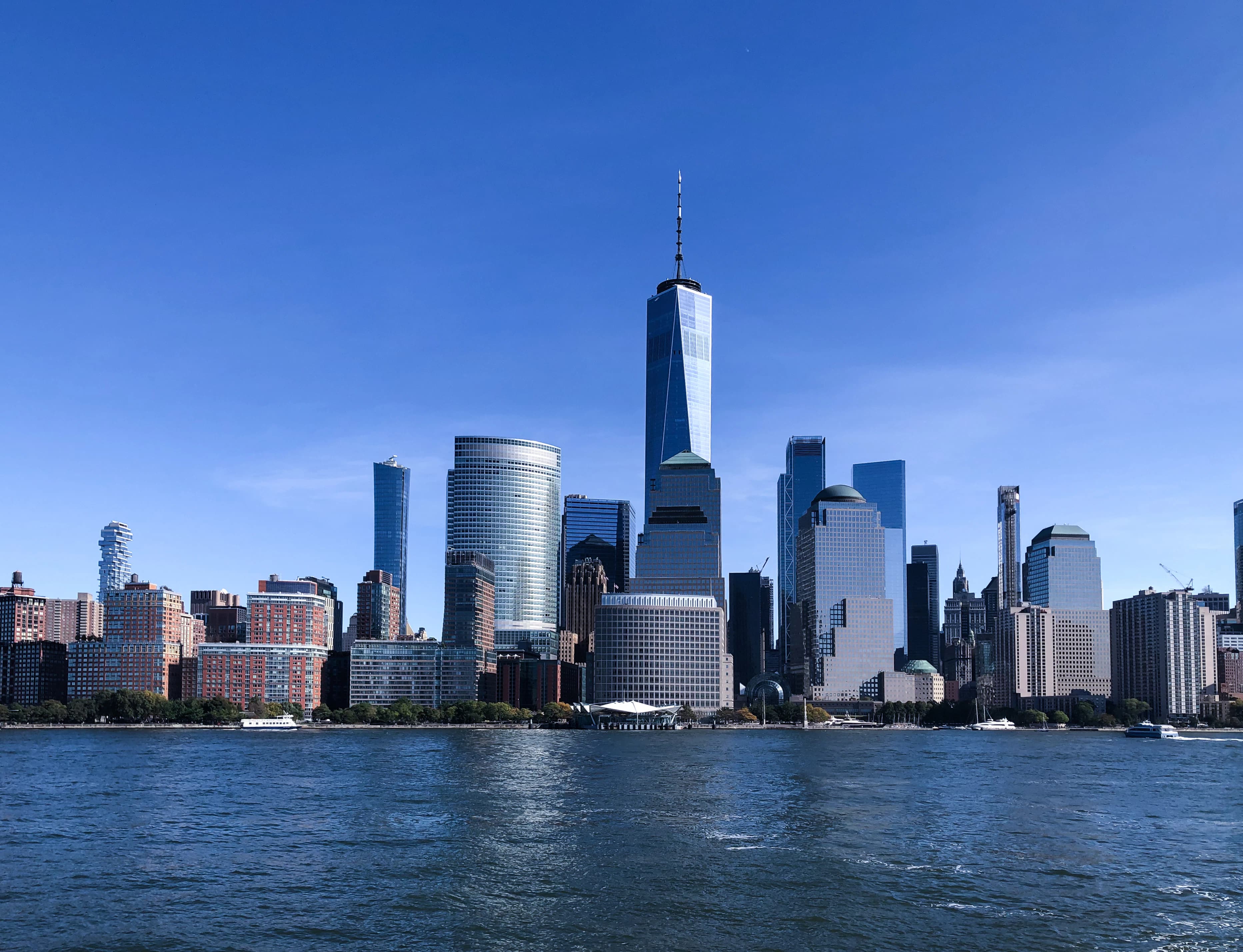 city skyline across body of water during daytime