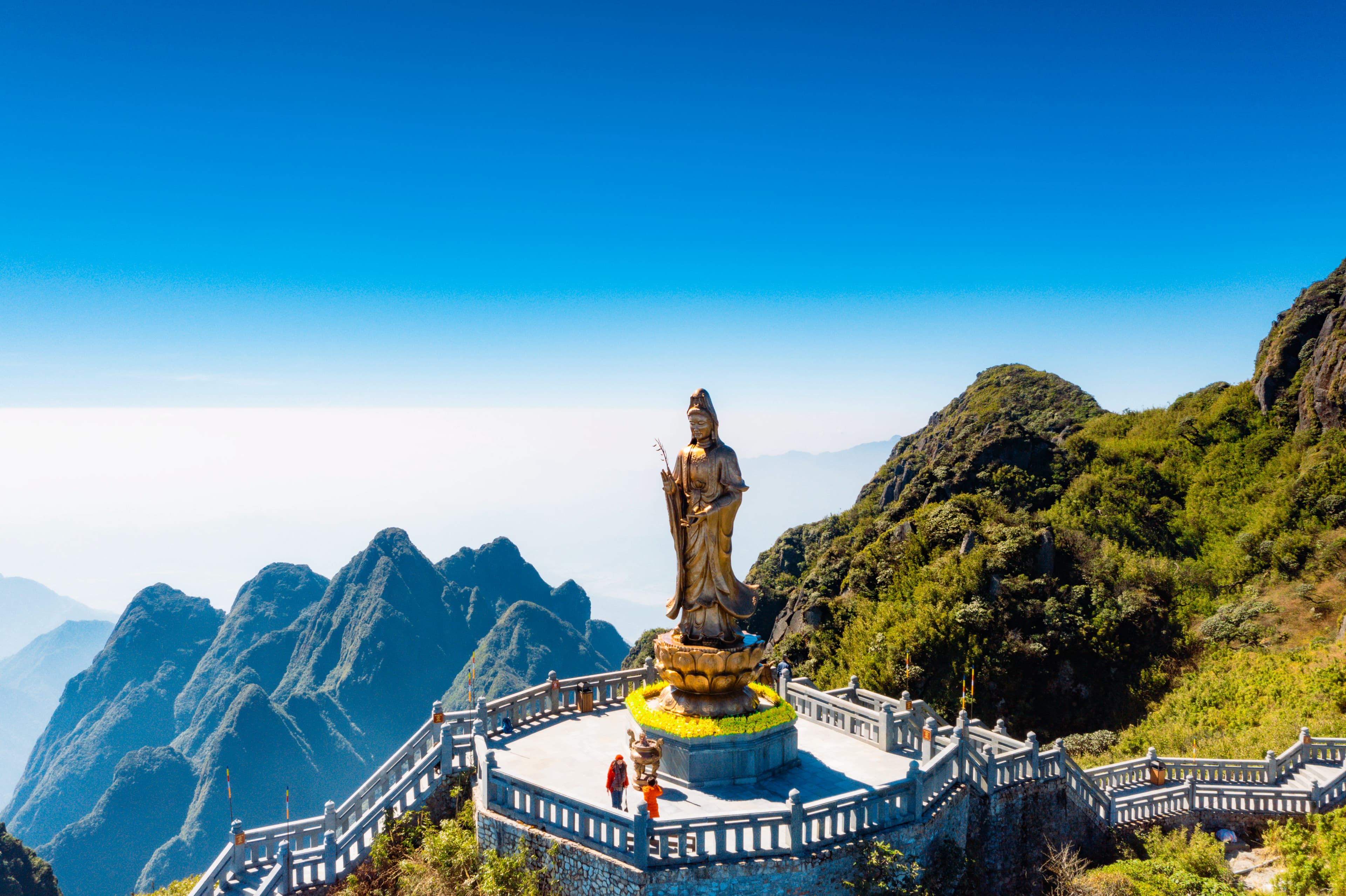 a statue of buddha on top of a mountain