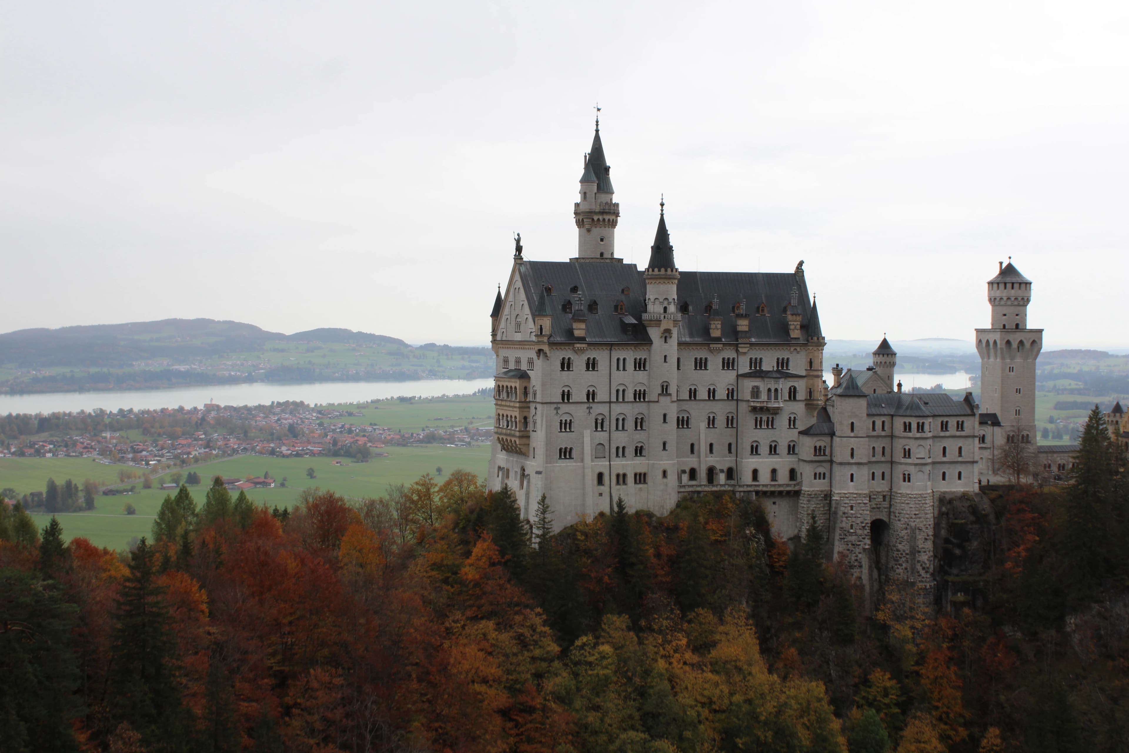 A large castle sitting on top of a lush green hillside